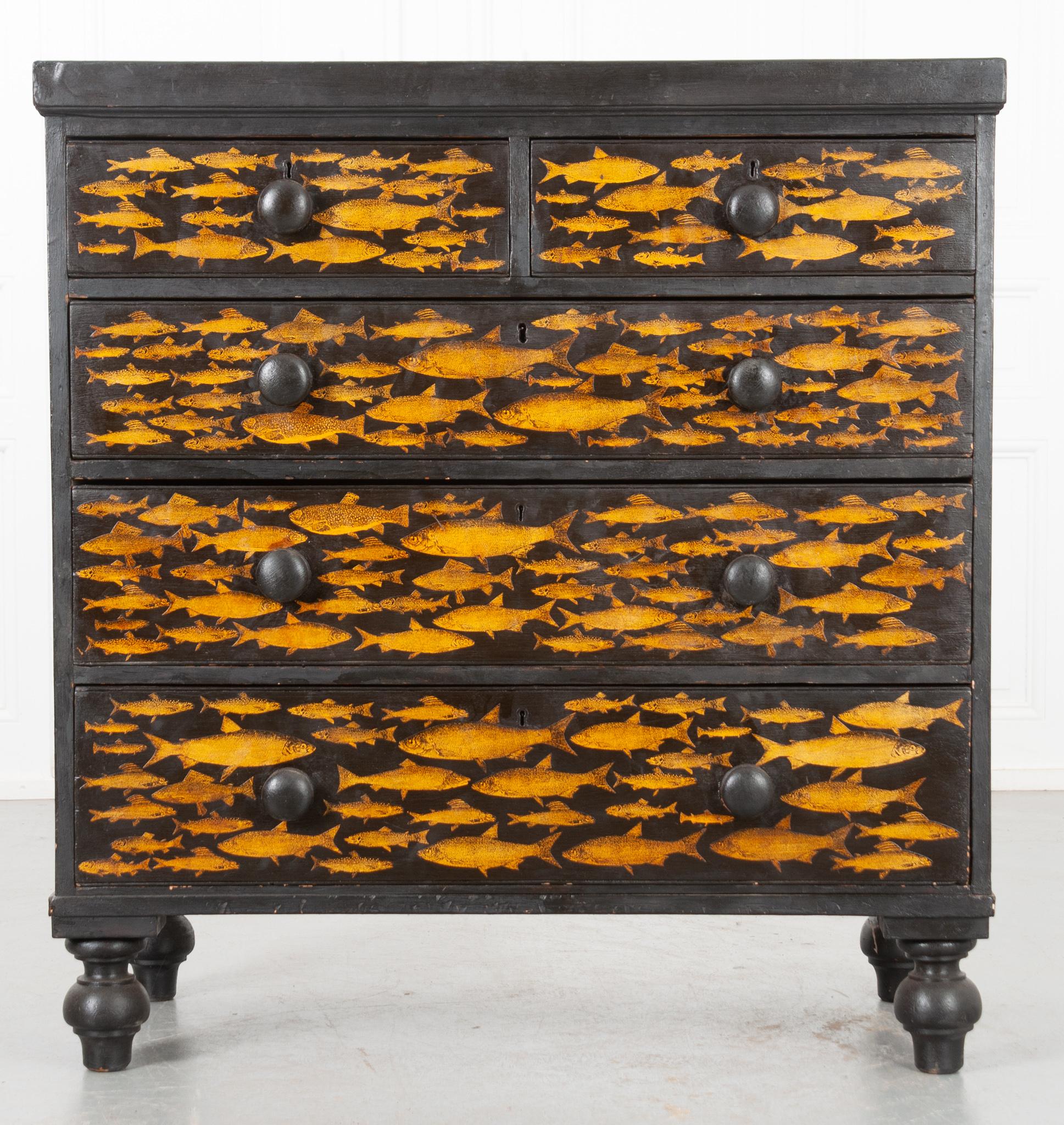 A playful twist on an antique pine chest of drawers. Recently painted black with a fish decoupage design. This chest will add a whimsical flair to any room in your house, especially a bedroom as there is plenty of storage inside its five drawers all