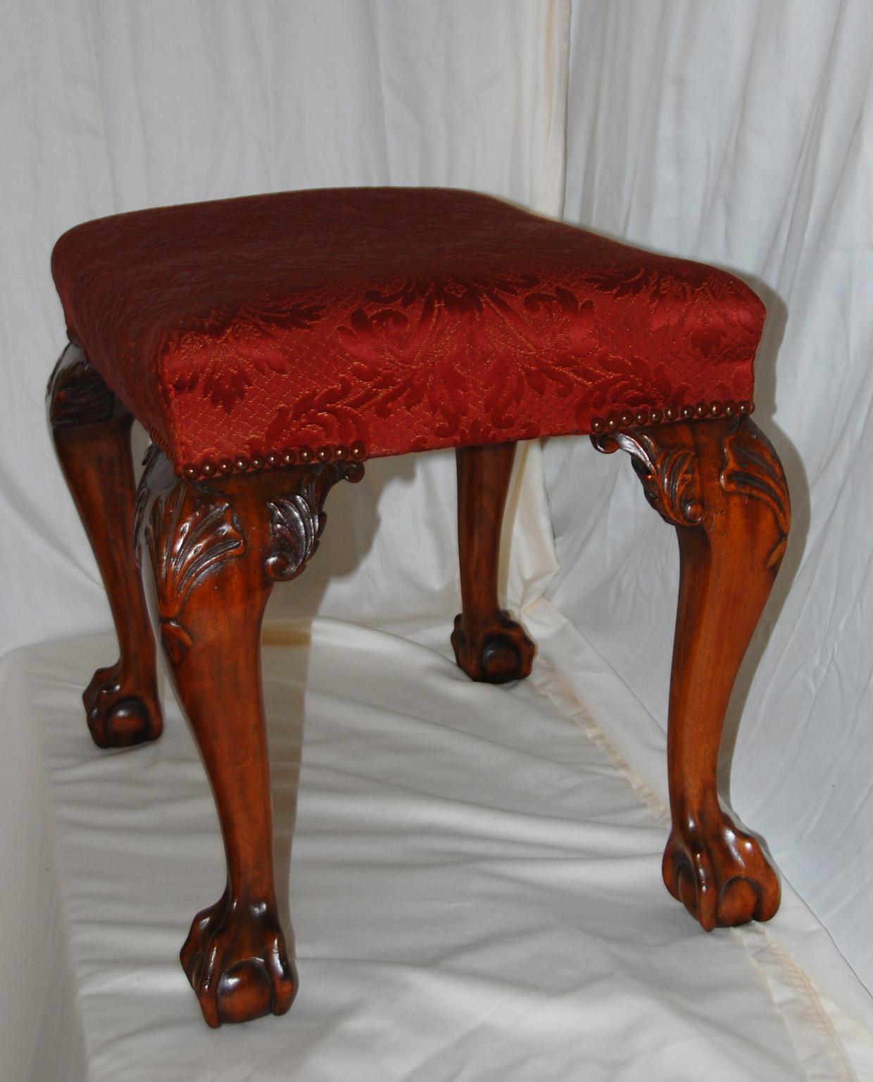 English Chippendale style mahogany upholstered stool with carved cabriole legs, ball and claw feet and shell carved knees. This substantial stool conforms well with the Chippendale style, having high quality timber, well carved detailing and classic