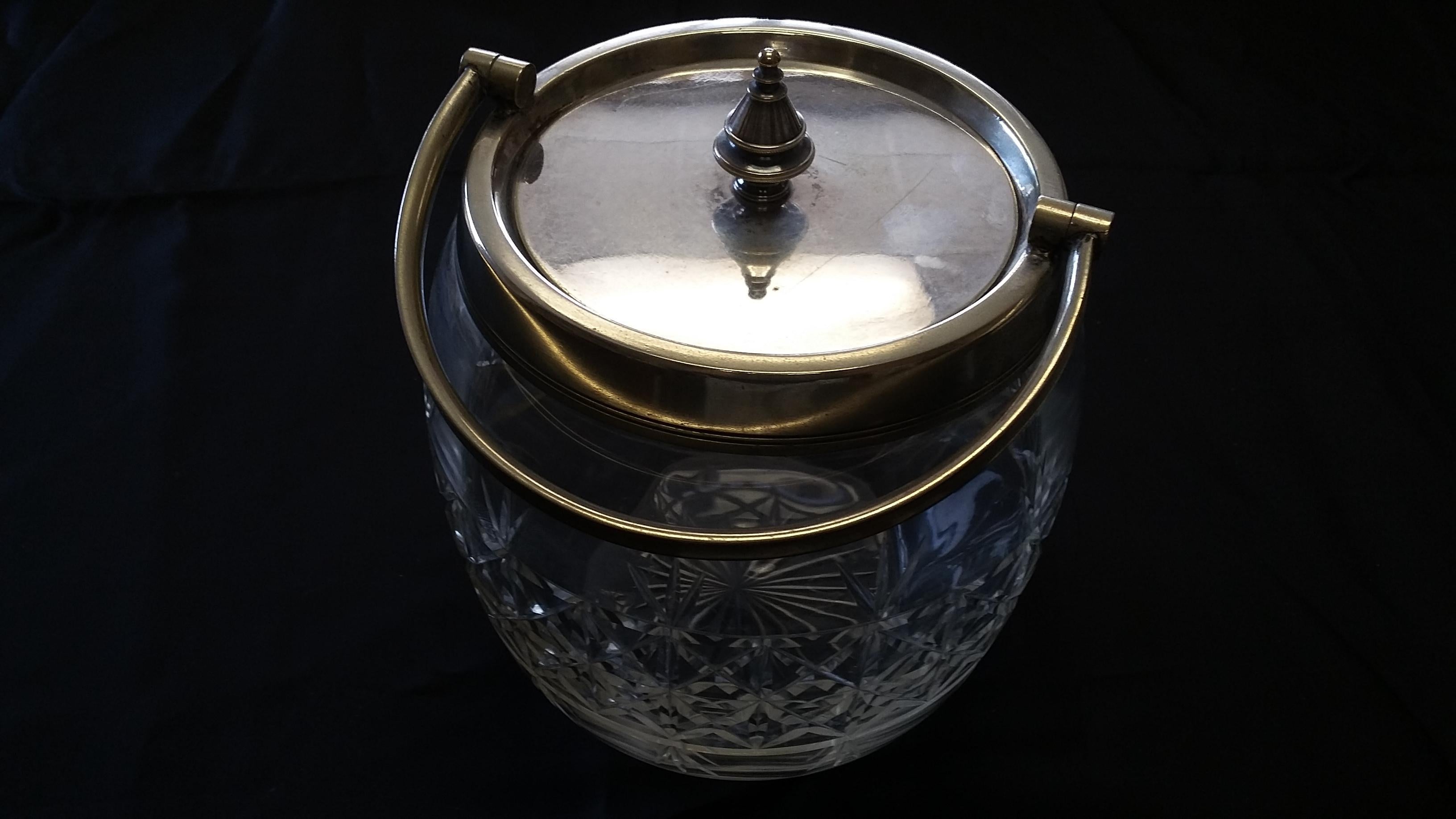 Beautiful cut glass crystal biscuit jar with silver plated rim and handle. Made in England, circa 1870. Square cut pattern on the jar. A very nice antique piece.