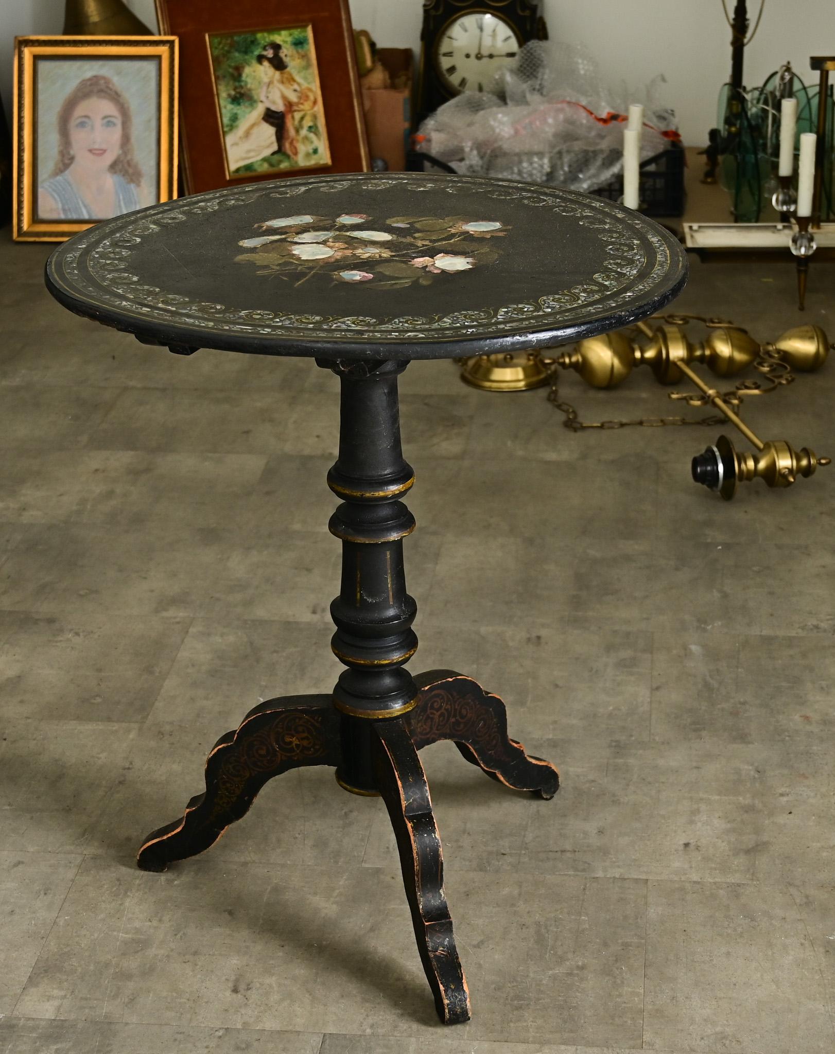 A magnificent English Victorian tea table (late 19th century) of ebonized wood and inlaid with mother-of-pearl on the surface. Deep ebonized color & texture of the wood contrasts beautifully with the kaleidoscopic inlay of mother-of-pearl tesserae