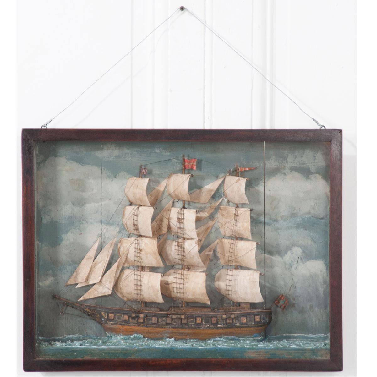 A brilliant English, 19th century nautically themed diorama featuring a schooner in a stained wood, framed box. These three-dimensional works of art were typically made by sailors. Note the meticulously detailed sails, masts, ropes, netting and