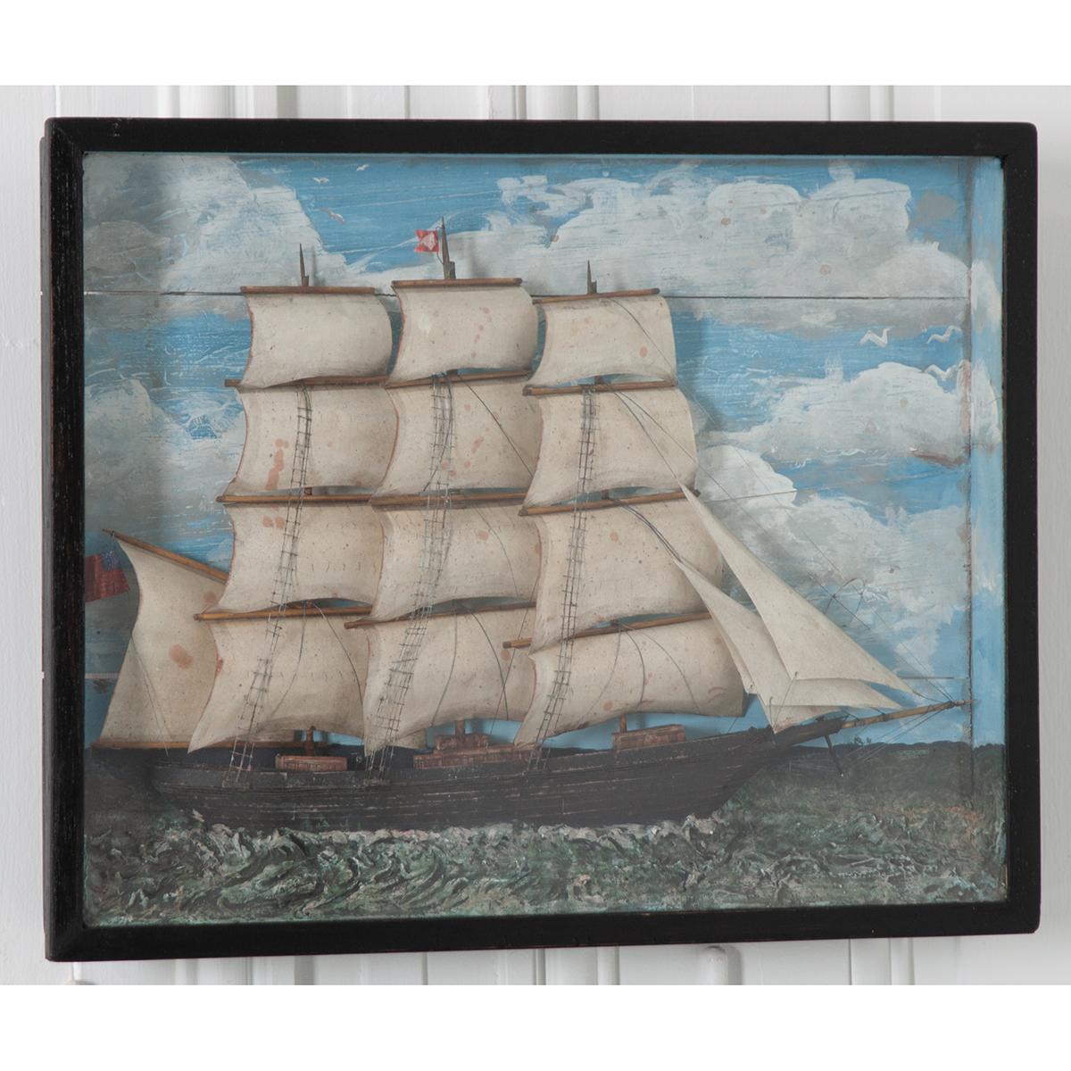 A brilliant English 19th century nautically themed diorama featuring a schooner. These three dimensional works of art were typically made by sailors in the 19th century. This diorama depicts a schooner at sea, but near the coast. Note the