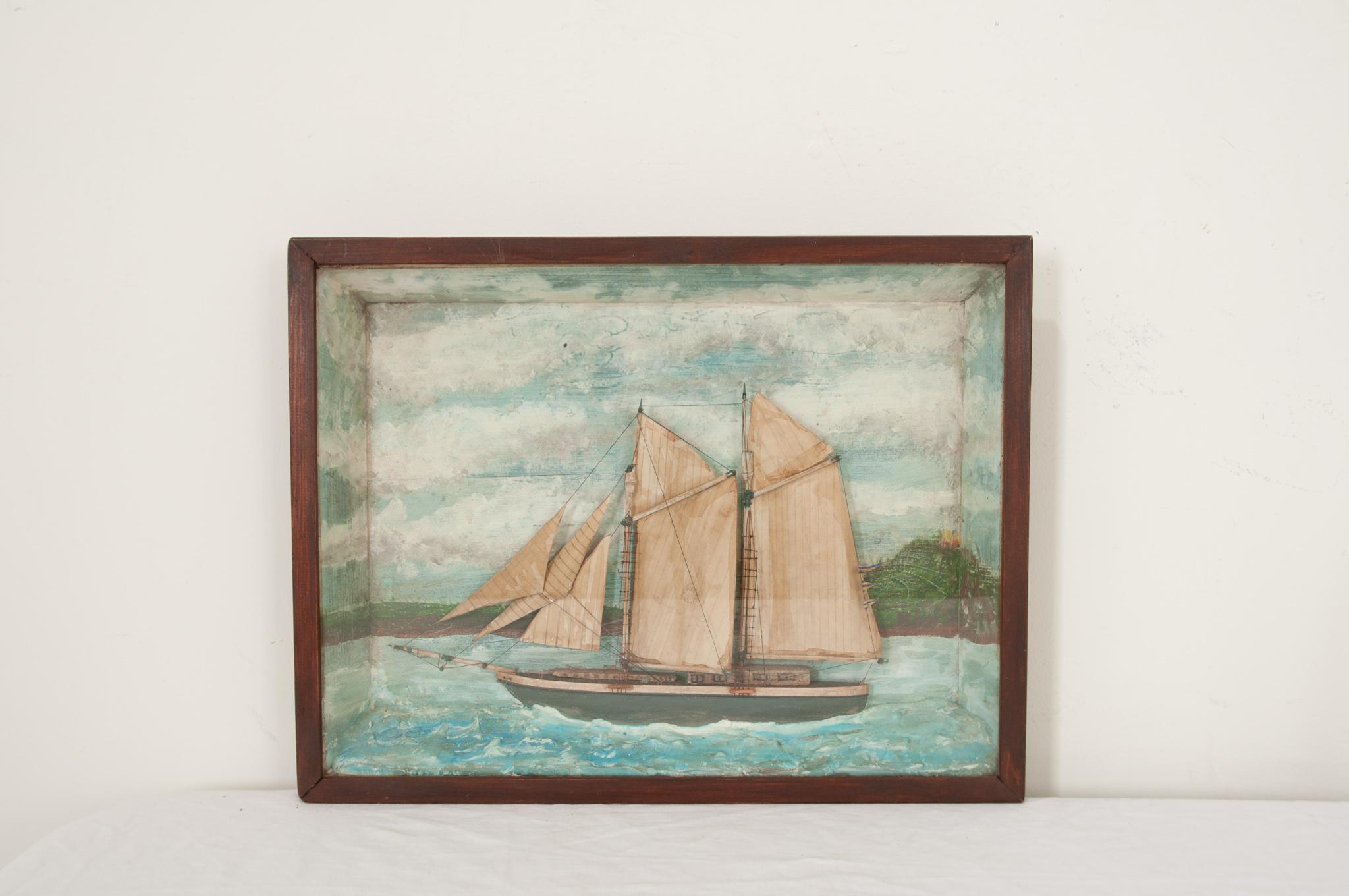 A brilliant nautical diorama hand-crafted in England circa 1890 featuring a sailing boat with beautifully detailed sails, masts, ropes, and netting. The boat is mounted on painted plaster waves and under glass in a wooden shadow box. These wonderful