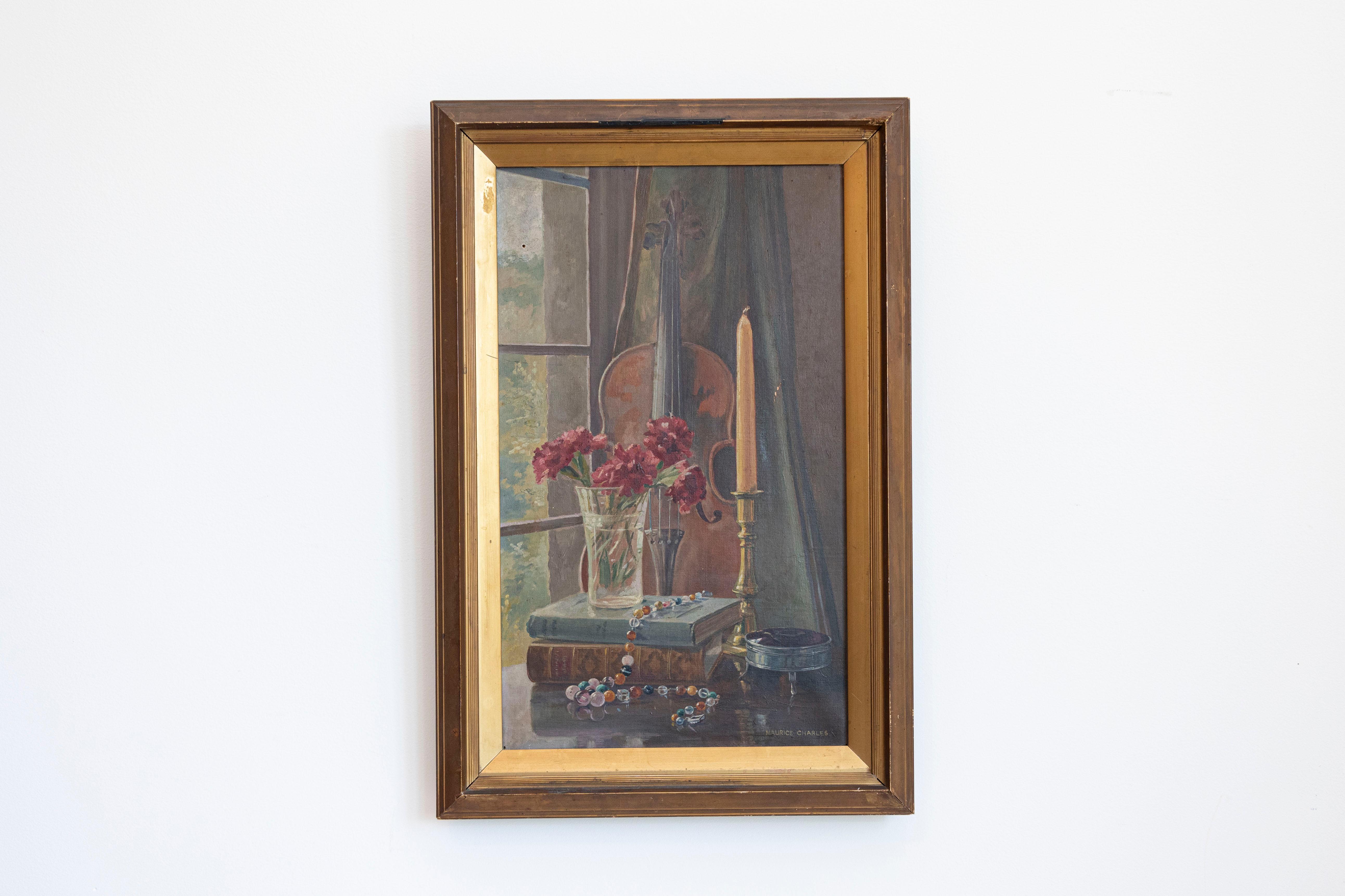 An English framed still-life painting from the 19th century depicting a violin, flowers and a candle, signed Maurice Charles. Created in England during the 19th century, this framed still-life depicts a delicate vignette made of a violin, whose
