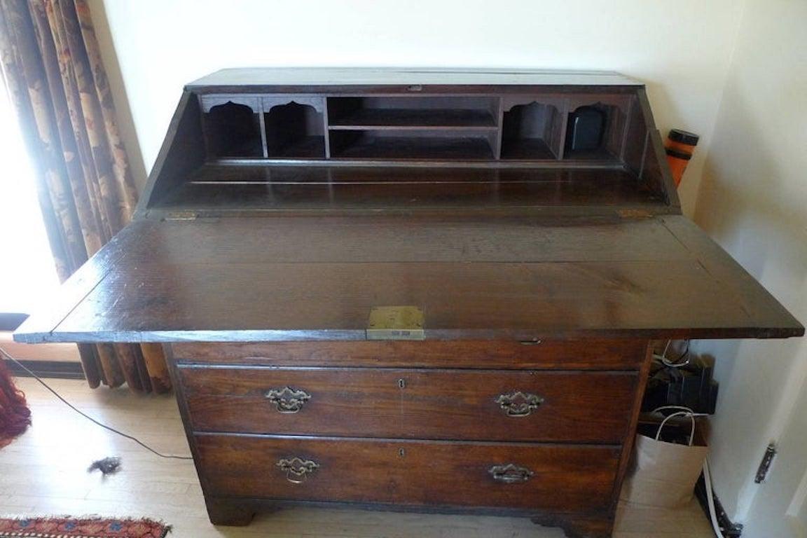 English 19th century Georgian chest of 5 drawers with drop panel desk top and original hardware.