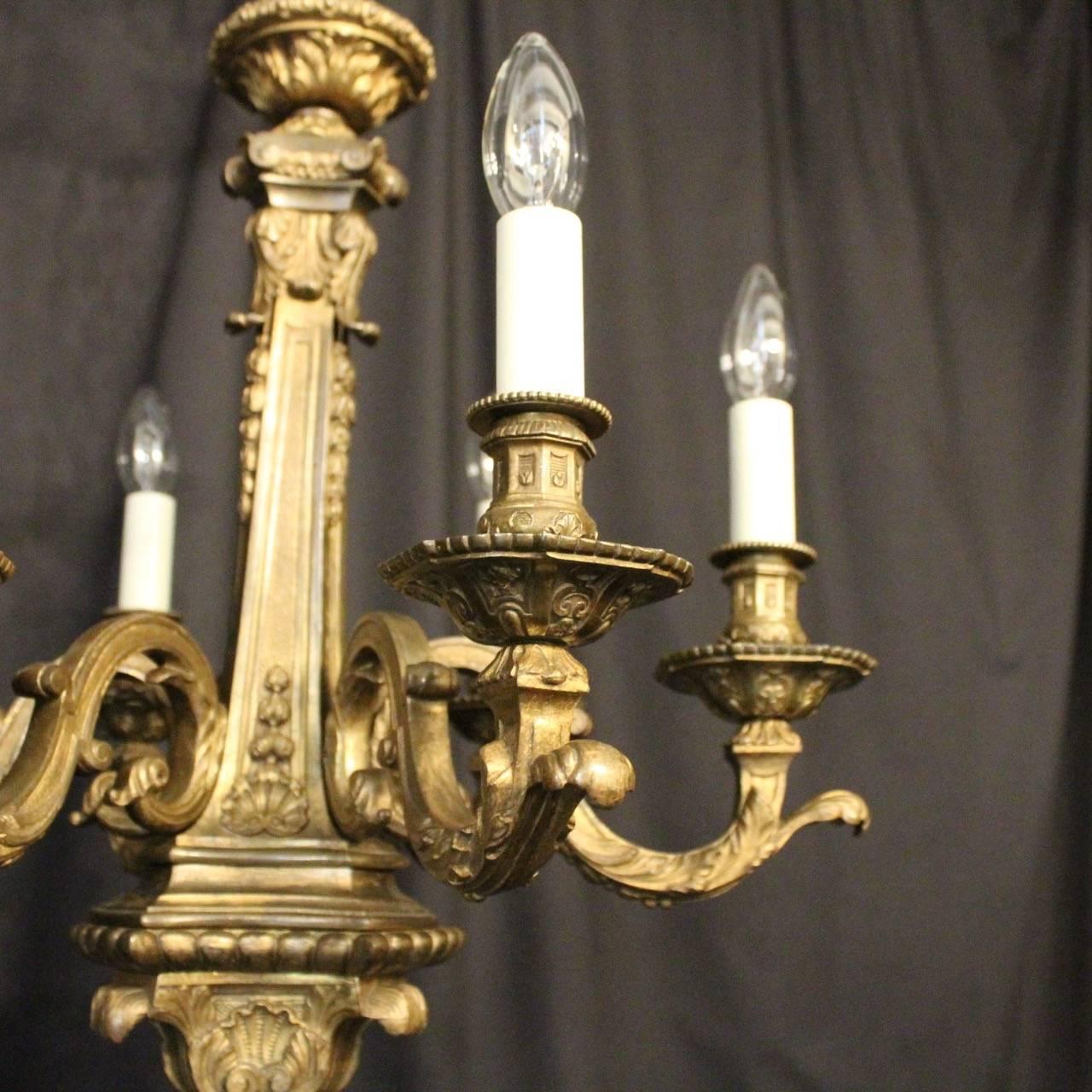 A quality English gilded cast bronze six-light antique chandelier, the ornate leaf scrolling arms with sectional leaf bobeche drip pans and ornate candle sconces, issuing from a tapering central column with lovely leaf base and having the original