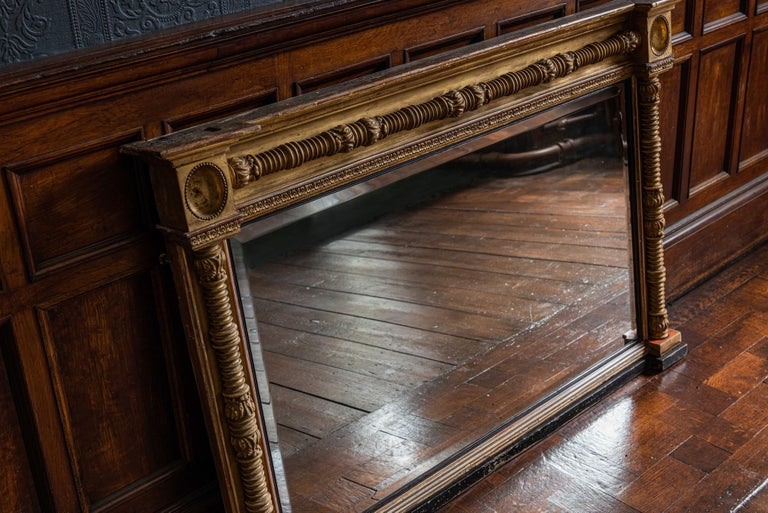 English 19th century gilt and ebonized beveled overmantle mirror
circa 1850.

Measures: 142 x 93 H x 14 D.