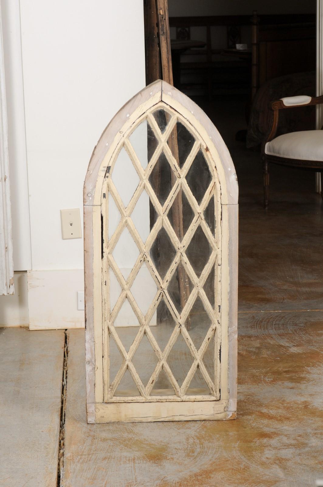 An English Gothic Revival painted wood broken arch church window frame from the 19th century, with latticed mullions and original finish. Created in England during the 19th century, this Gothic Revival window will make for an excellent decorative