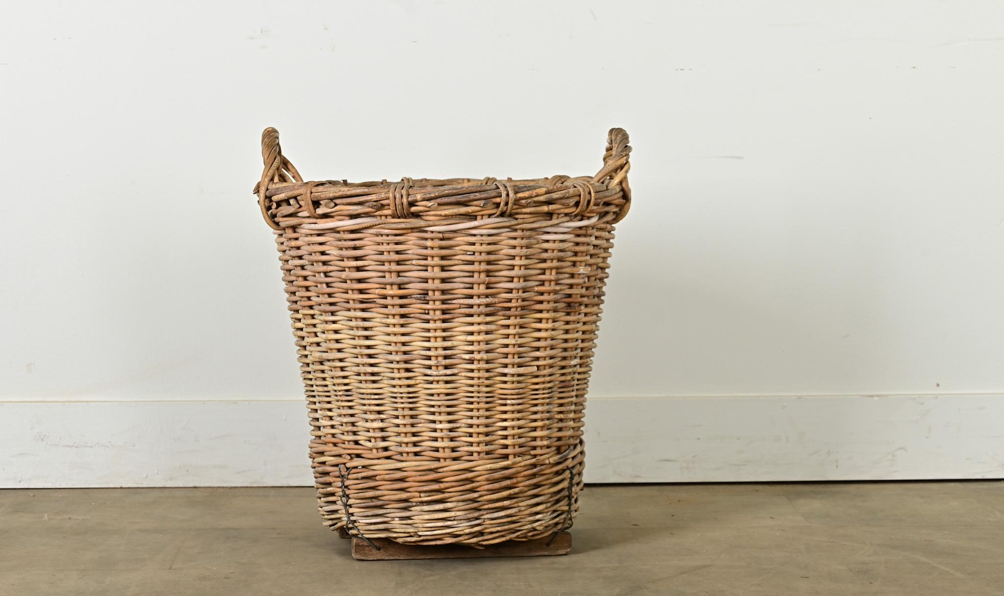 A charming English harvest basket from the later part of the 19th century, circa 1890. This sturdy basket was made to stand the test of time. Originally used to collect fruits, vegetables and other crops, today it would make a delightful laundry