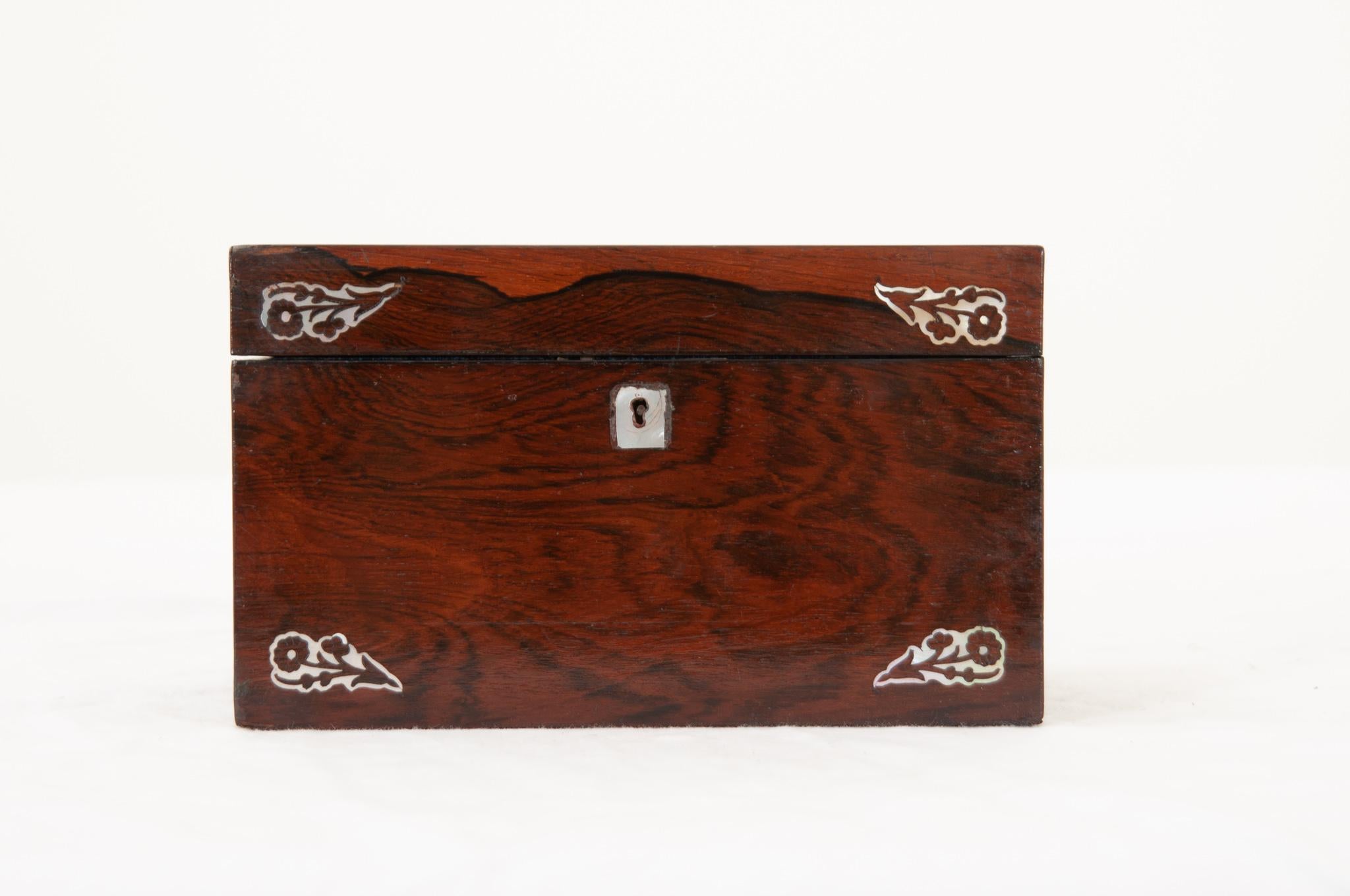 An English 19th century decorative box with lift up lid opening on original brass hinges to reveal a good sized storage compartment lined with the original hand-crafted sapphire blue printed paper. This handsome box features a fantastic red wood
