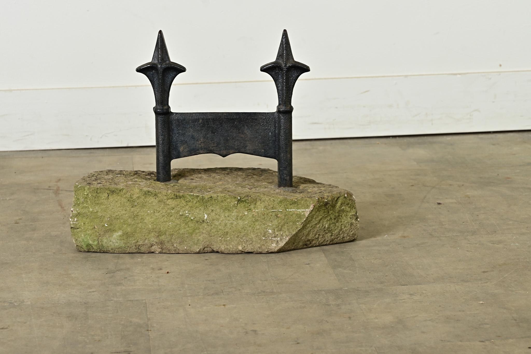 A sculptural cast iron boot scraper from England, circa 1870, designed to remove mud from shoes and boots before entering a home. This example offers a flat iron panel for scraping the sole, held upright between two posts with the silhouette of very