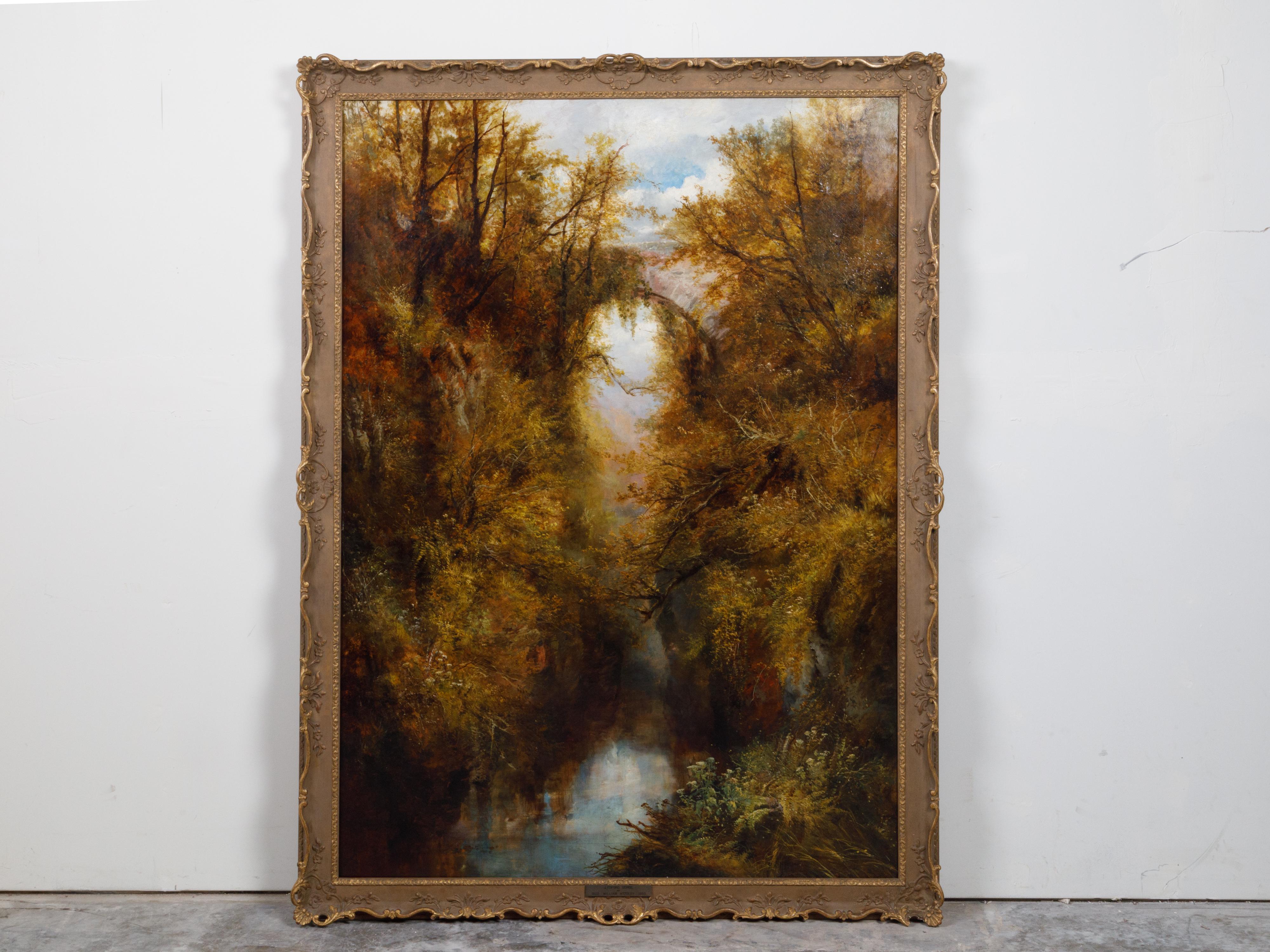 An English oil on canvas landscape painting by William Widgery (1822–1893) from the late 19th century depicting Lydford Gorge, in carved frame. Created in England during the second half of the 19th century, this vertical landscape depicts Lydford
