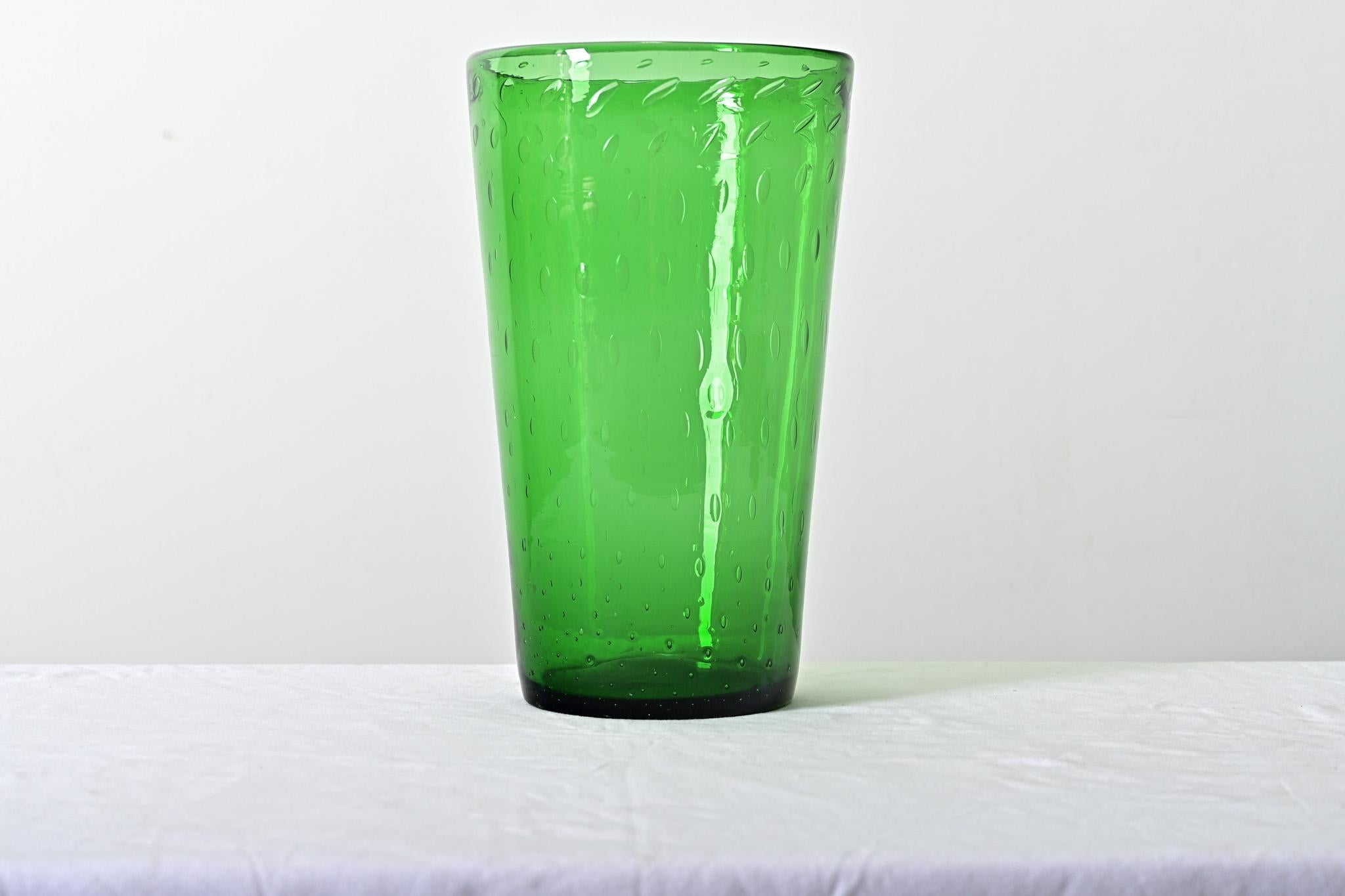 English, late 19th century green glass vase with bubbled or “bullicante” effect embedded in the glass. This large, conical vessel has a lovely emerald color to refract and reflect light as a work of art on its own or filled with a fresh bouquet to