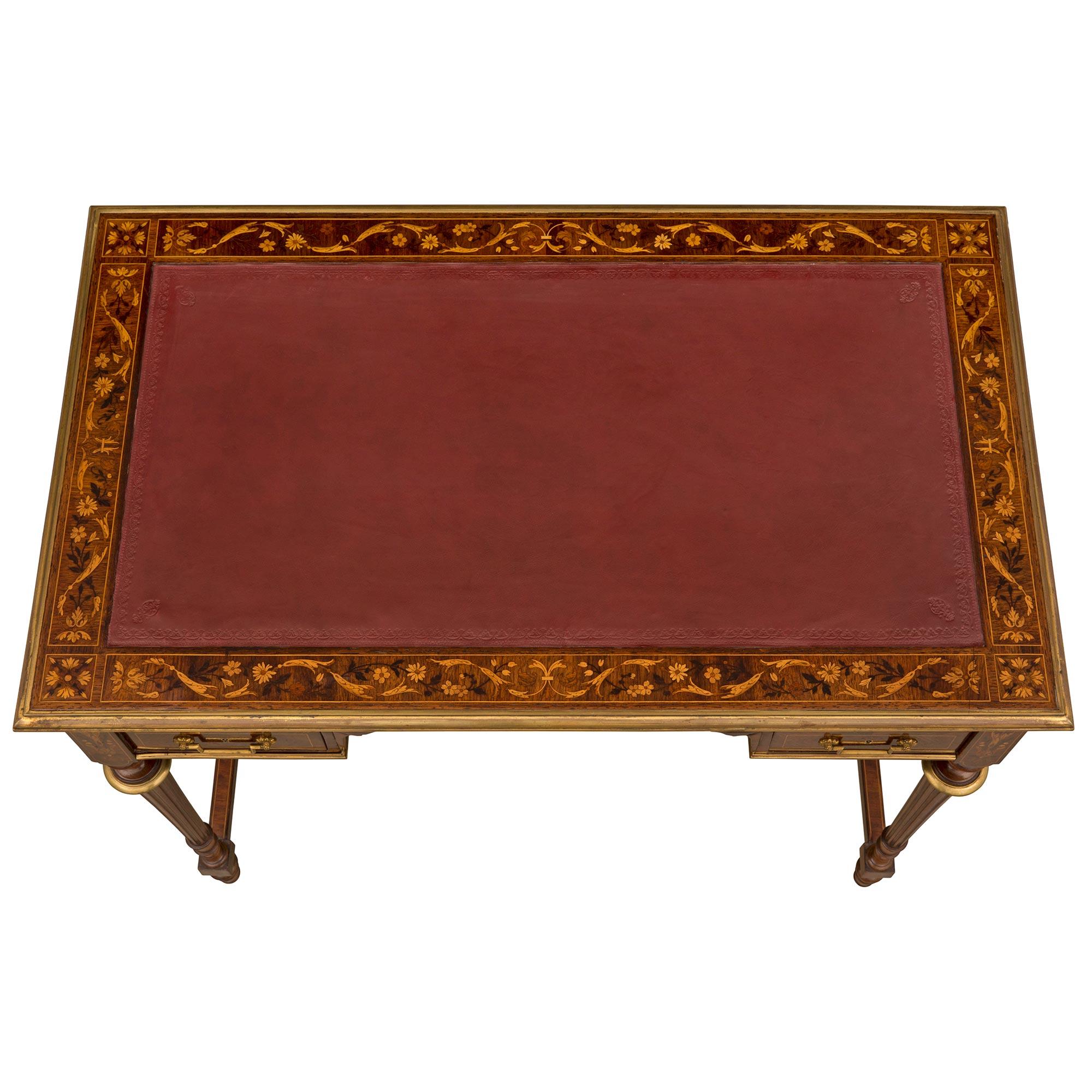 An elegant and very high quality English early 19th century Louis XVI st. Kingwood, Tulipwood, and ormolu desk signed HOBBS. The five drawer desk is raised by beautiful and unique topie shaped feet below block reserves each connected by a fine