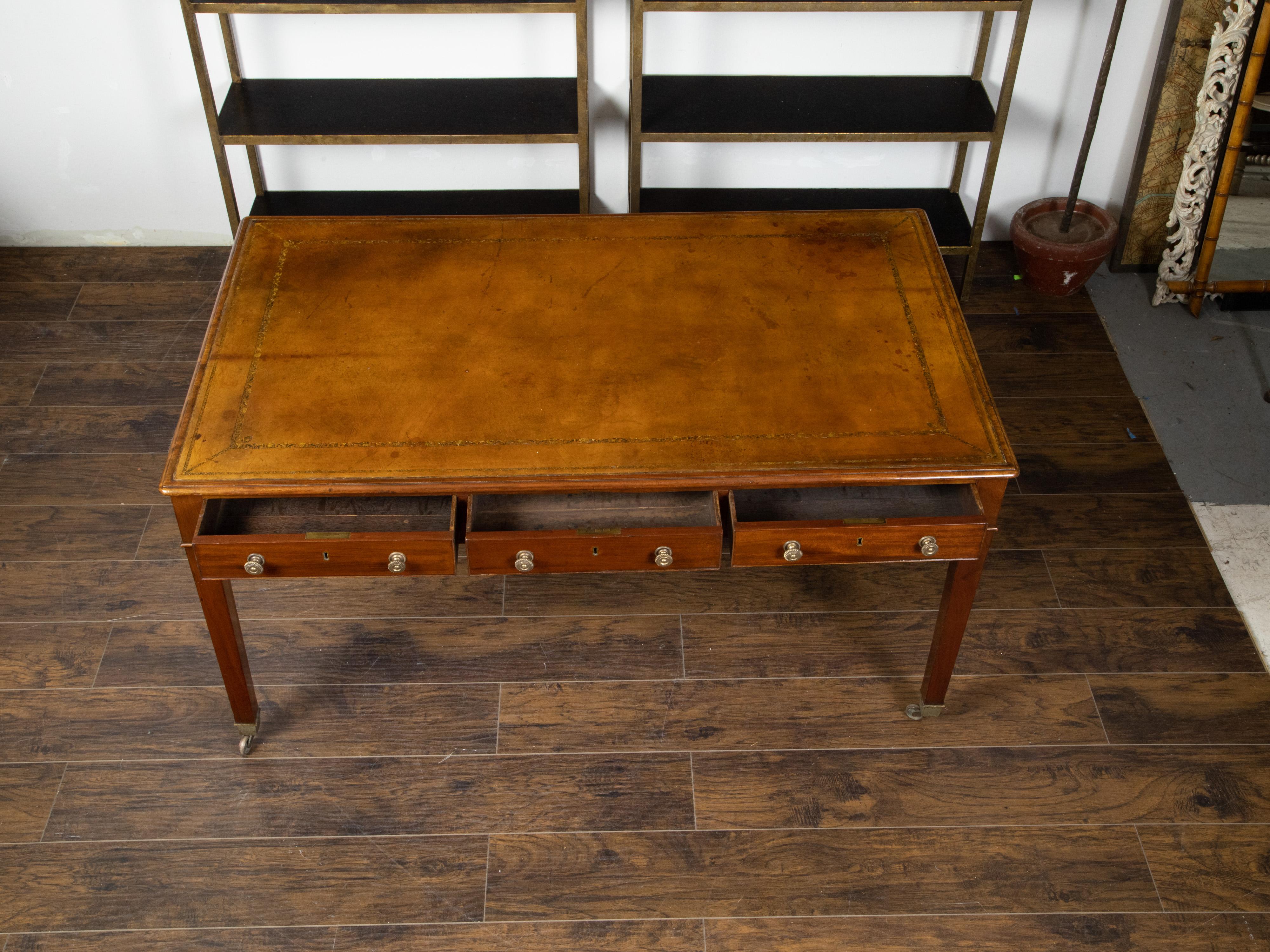 Gilt English 19th Century Mahogany Desk with Three Drawers, Mounted on Brass Casters