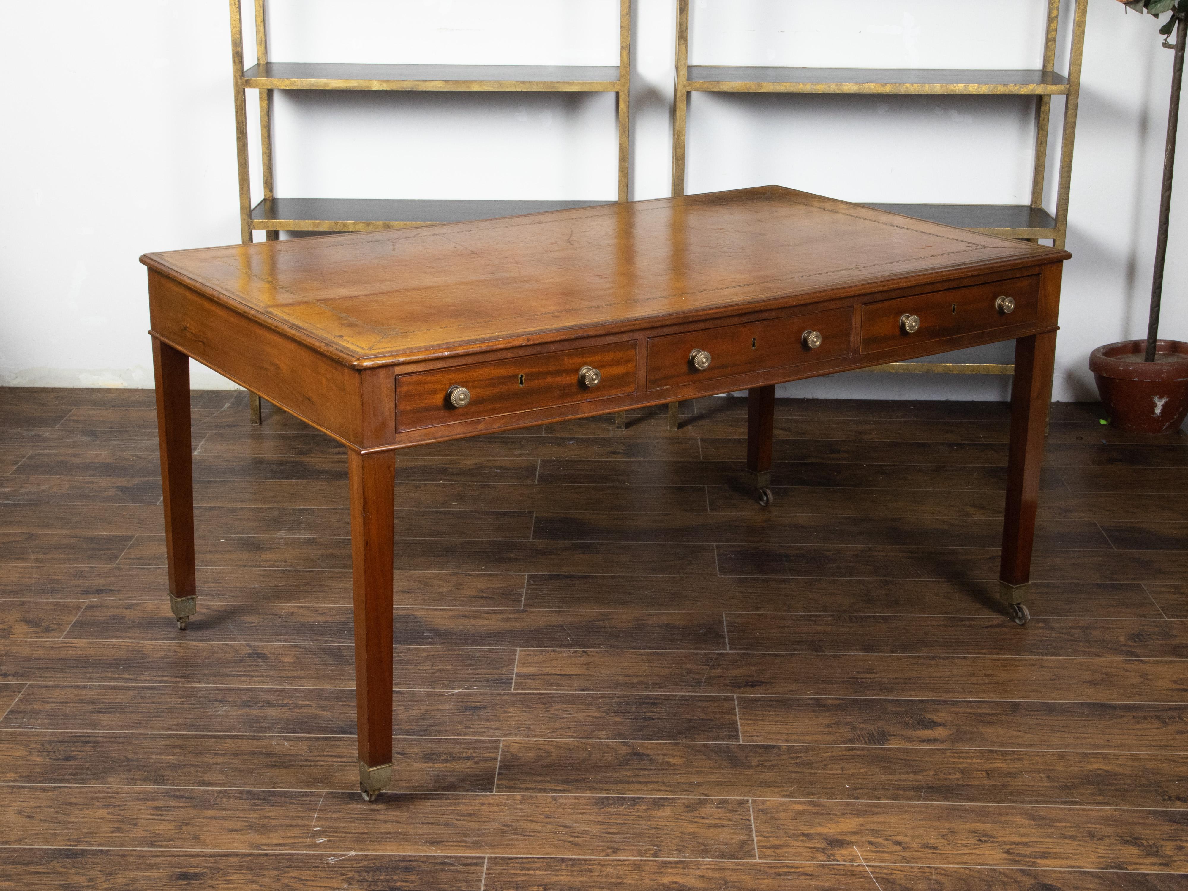 English 19th Century Mahogany Desk with Three Drawers, Mounted on Brass Casters In Good Condition In Atlanta, GA