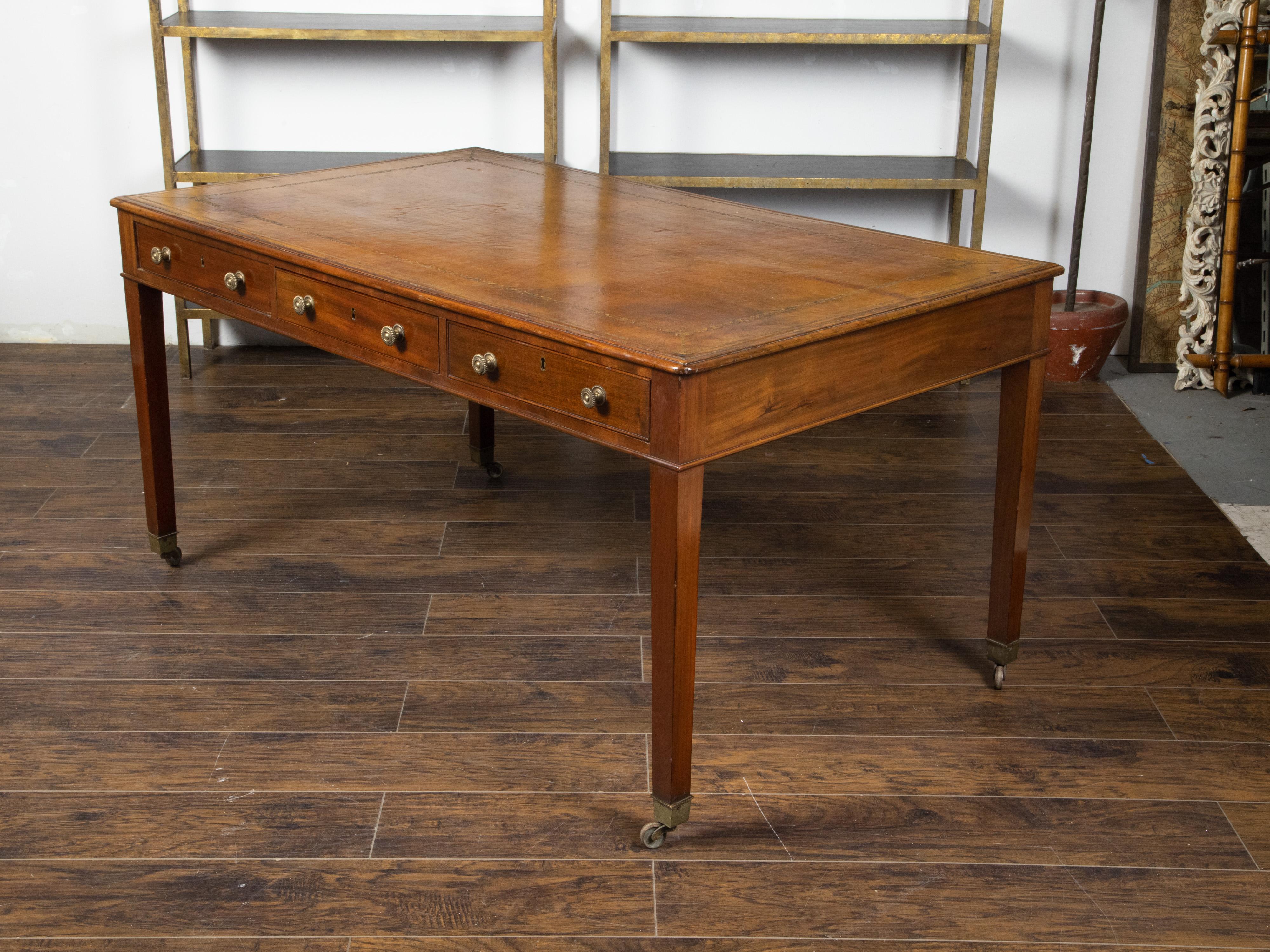 English 19th Century Mahogany Desk with Three Drawers, Mounted on Brass Casters 1