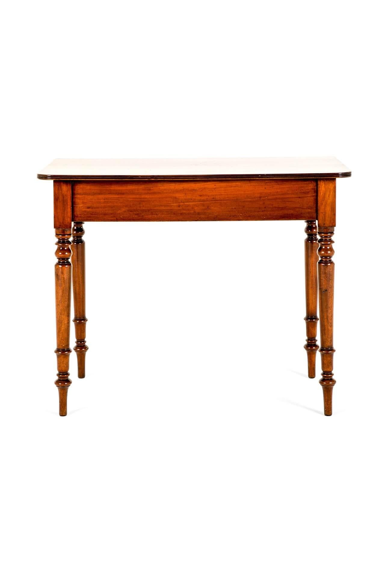 A superb 19th century mahogany hall table in good country house condition.

A thin rectangular moulded top with gently reeded detailing to the rim leads to a simple generous frieze.

The table is raised on four turned gently tapering legs on arrow