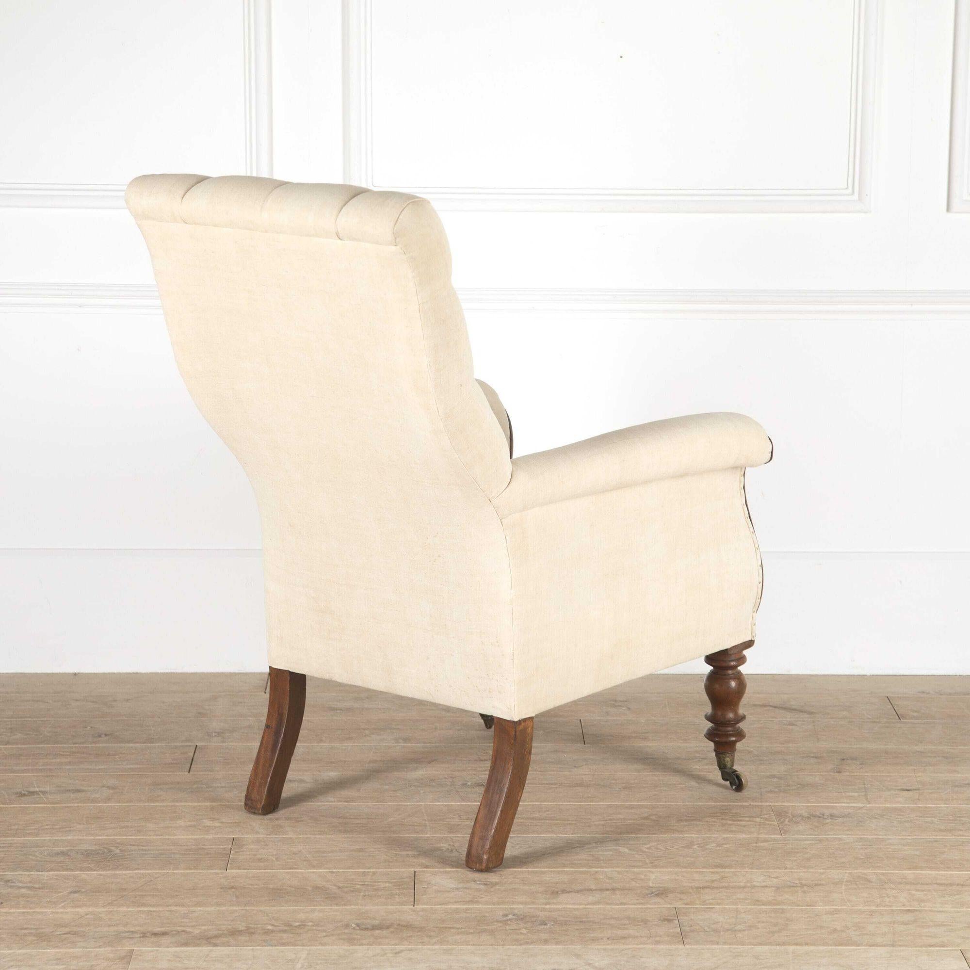 Early 19th century William IV mahogany library armchair.
This classic armchair features a deep-buttoned rectangular back, which has been re-upholstered in antique linen.
With lovely scroll armrests and boldly turned front legs with original