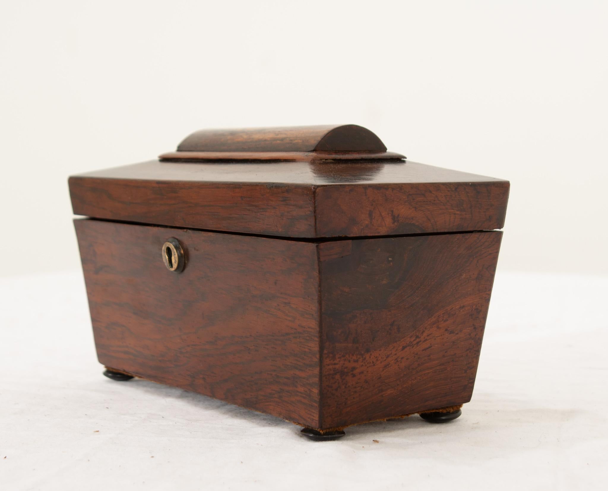 An English 19th Century mahogany tea caddy having a beautifully molded and trimmed lift up top opening to reveal two mahogany lift off lids with lovely turned wooden pulls that open two roomy tea compartments. The top is lined with the original