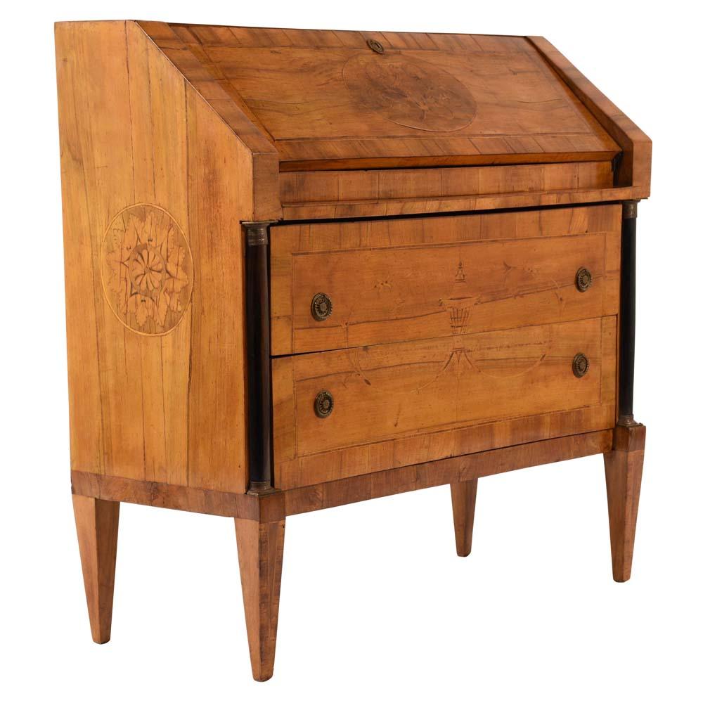 This 1900s antique neoclassical style drop front desk is made of walnut wood in its original light walnut color finish. Adorning the sides of the desk are inlaid designs of floral, leafy, and urn designs. Inside the drop-top, there are four small
