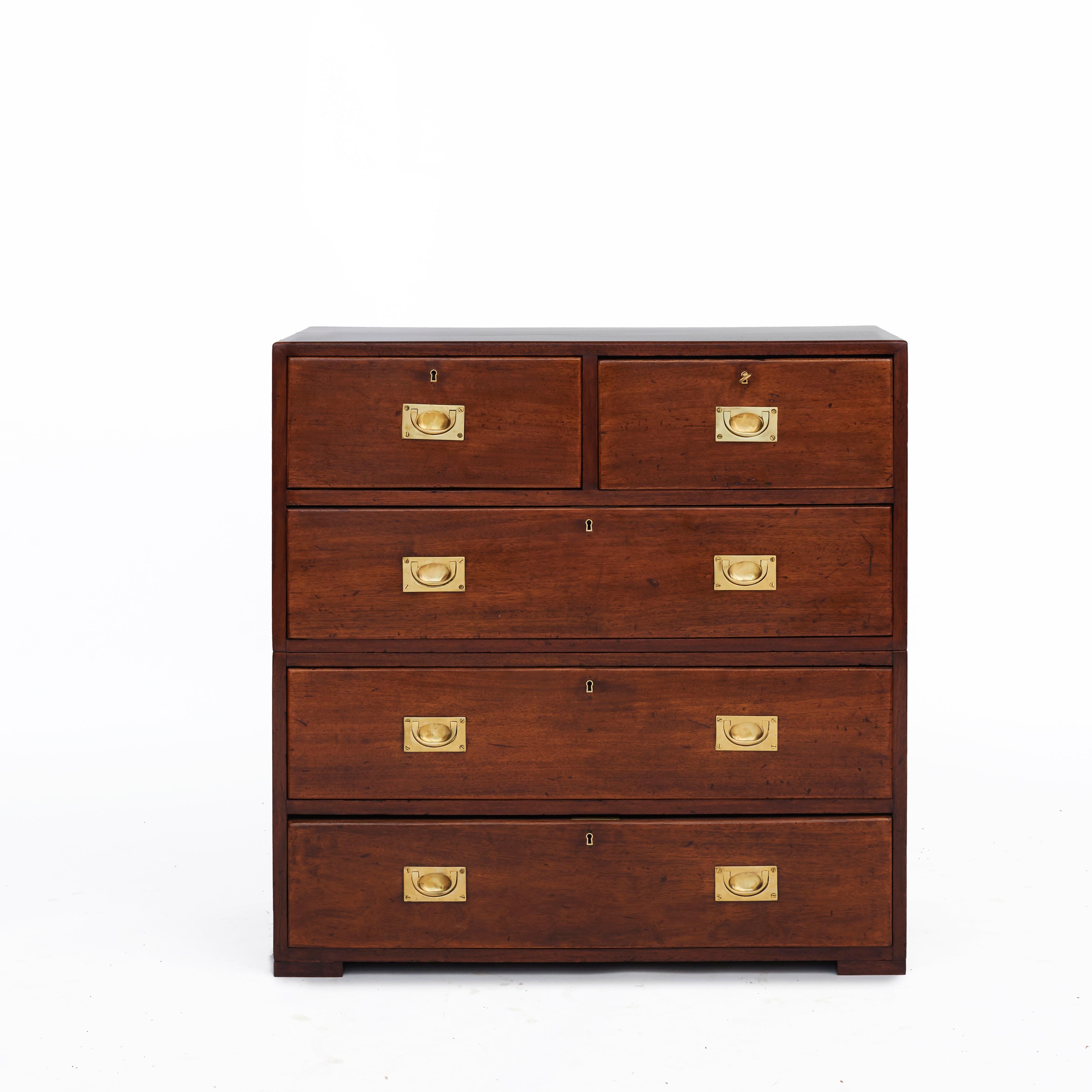 English military officer’s Campaign chest of drawers. Made solid mahogany with original brass fittings.
In two parts. Traditional formation with three over two drawers.
The locks on the two upper drawers have later been replaced with iron locks.