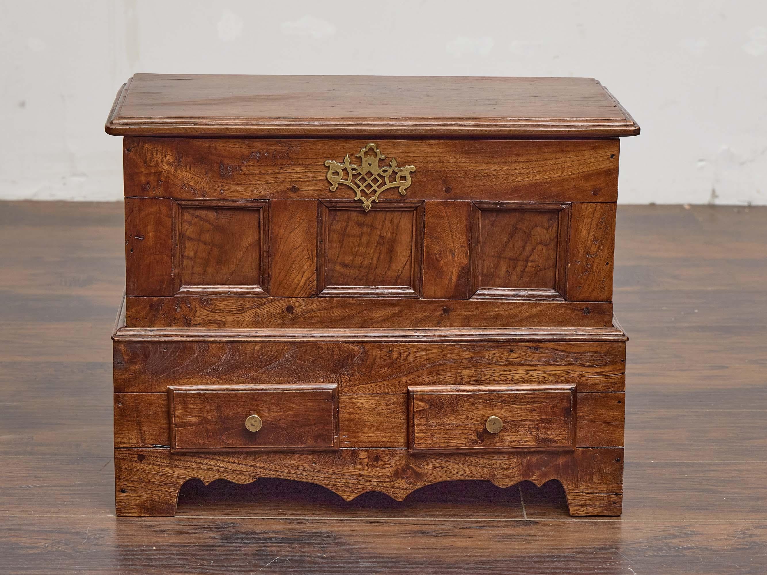 An English oak chest from the 19th century, combining traditional paneled craftsmanship with practical storage features. The hinged rectangular top opens to reveal a deep, open compartment, ideal for storing linens, documents, or personal treasures.