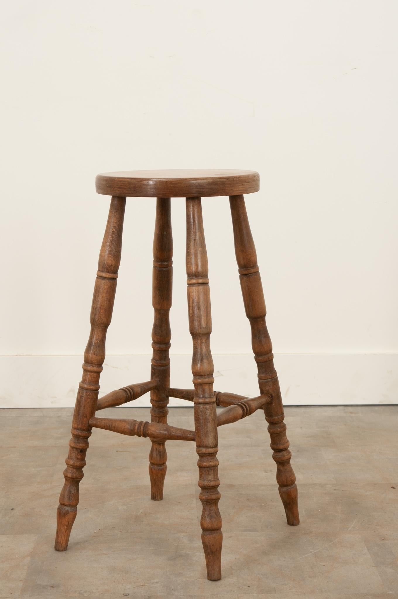 This simply constructed counter stool was crafted from solid oak in England during the 19th century. A great patina envelops the whole. Sturdy and level on wonderfully turned legs. Make sure to view the detailed images for a closer look.