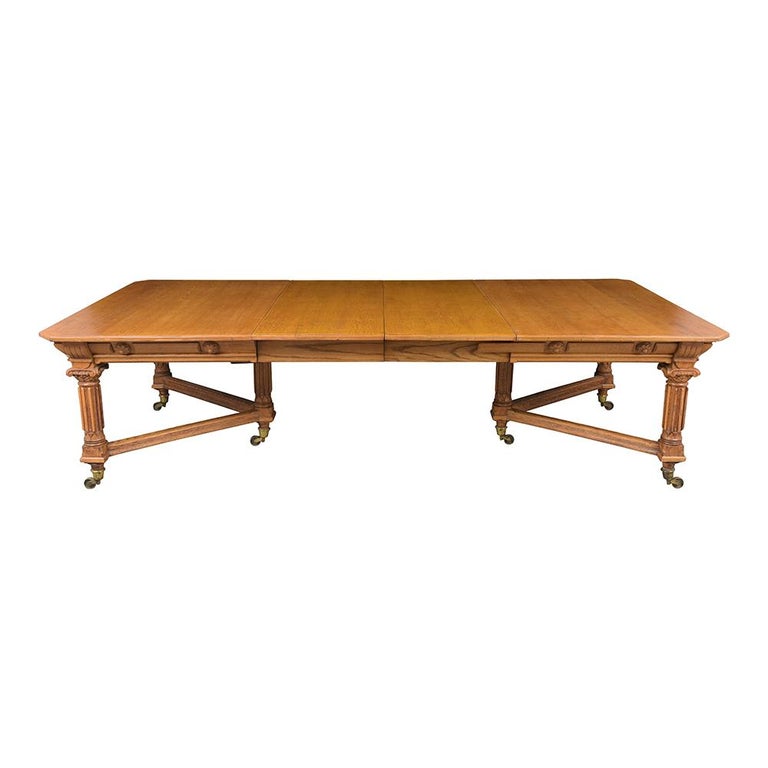 A remarkable English 19th Century Oak Dining Tablein in great condition made out of solid oak wood stained in a golden oak color and restored by our team of craftsmen. The table has an extendable mechanism in working condition, and two leaves that