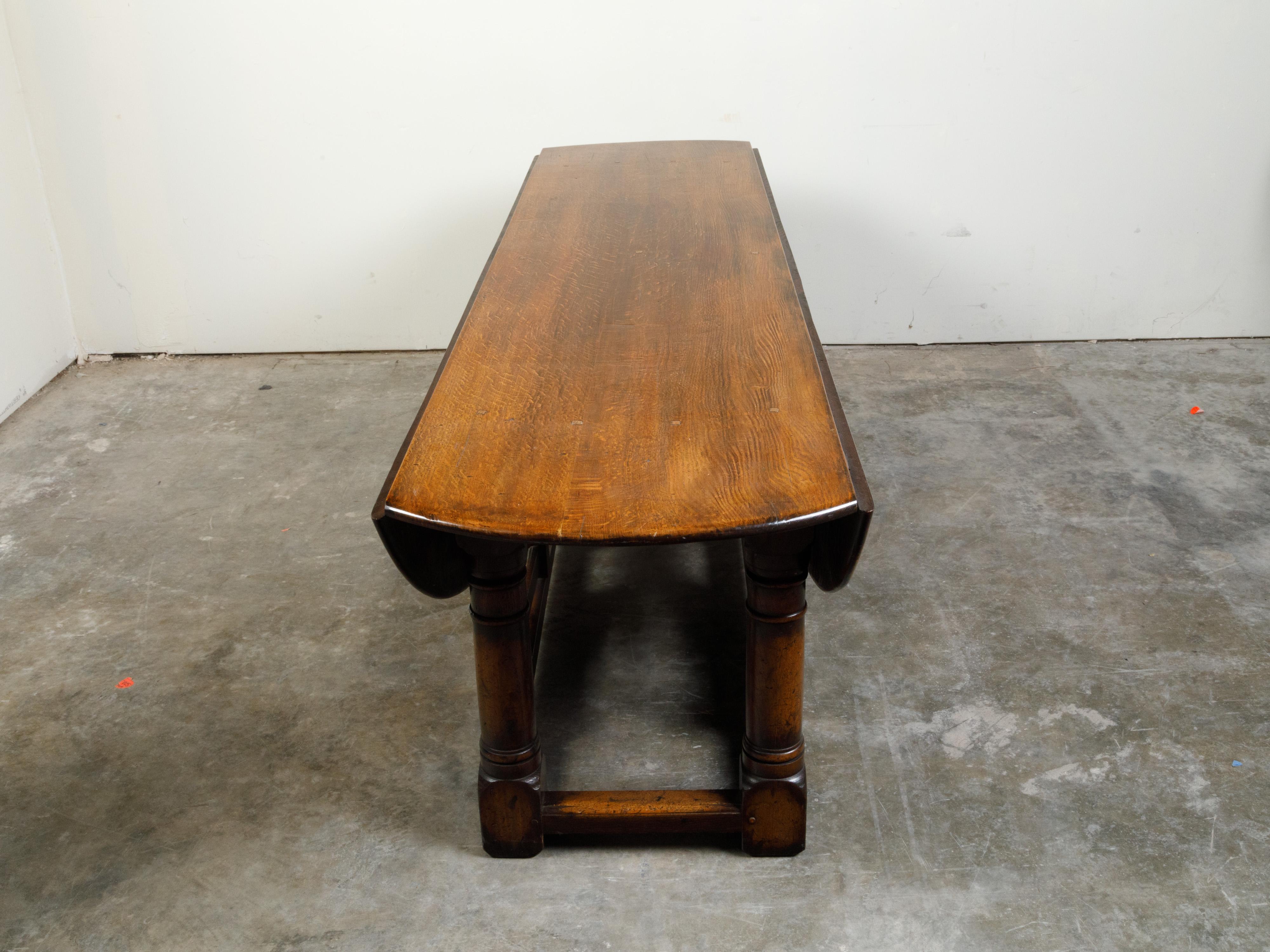 Turned English 19th Century Oak Drop-Leaf Oval Top Table with Gateleg Base