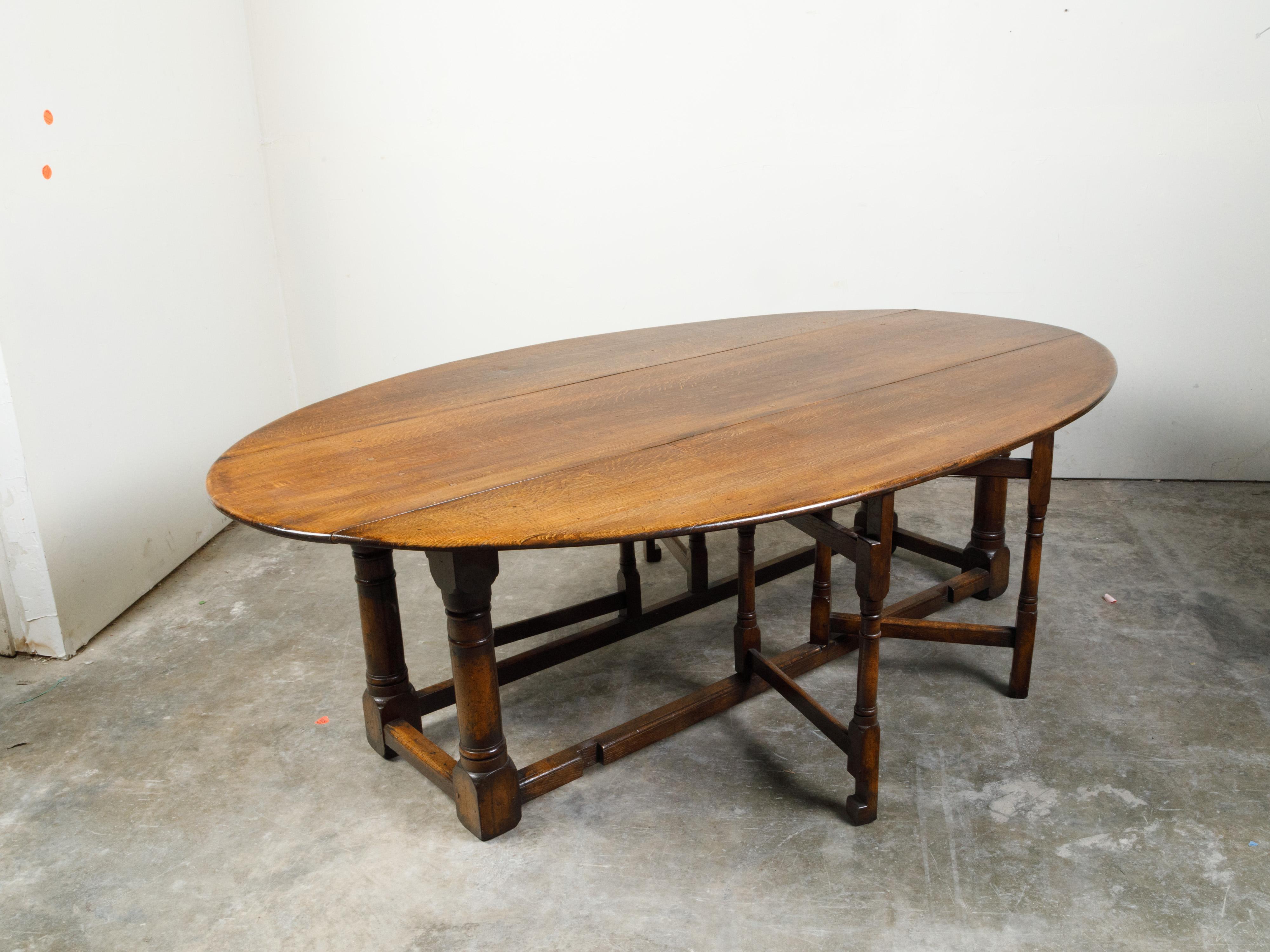 English 19th Century Oak Drop-Leaf Oval Top Table with Gateleg Base 1