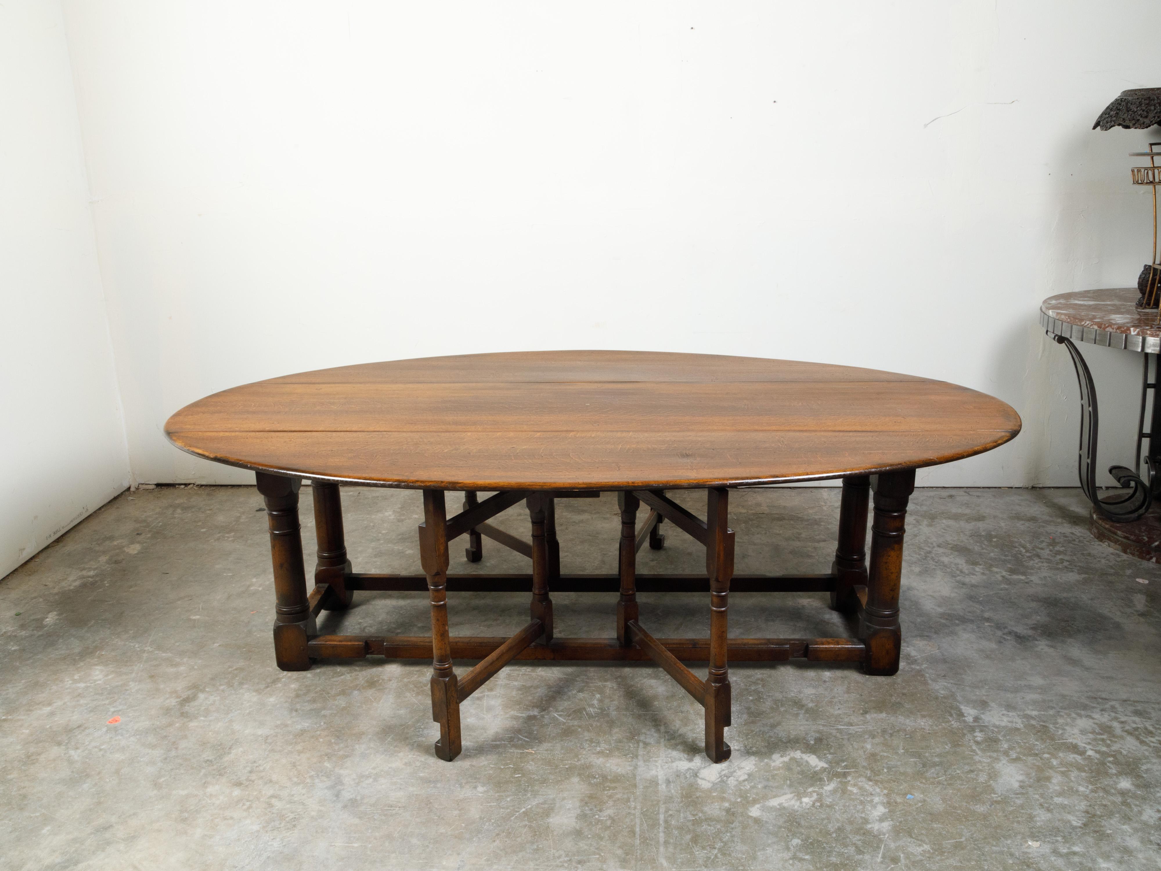 English 19th Century Oak Drop-Leaf Oval Top Table with Gateleg Base 4