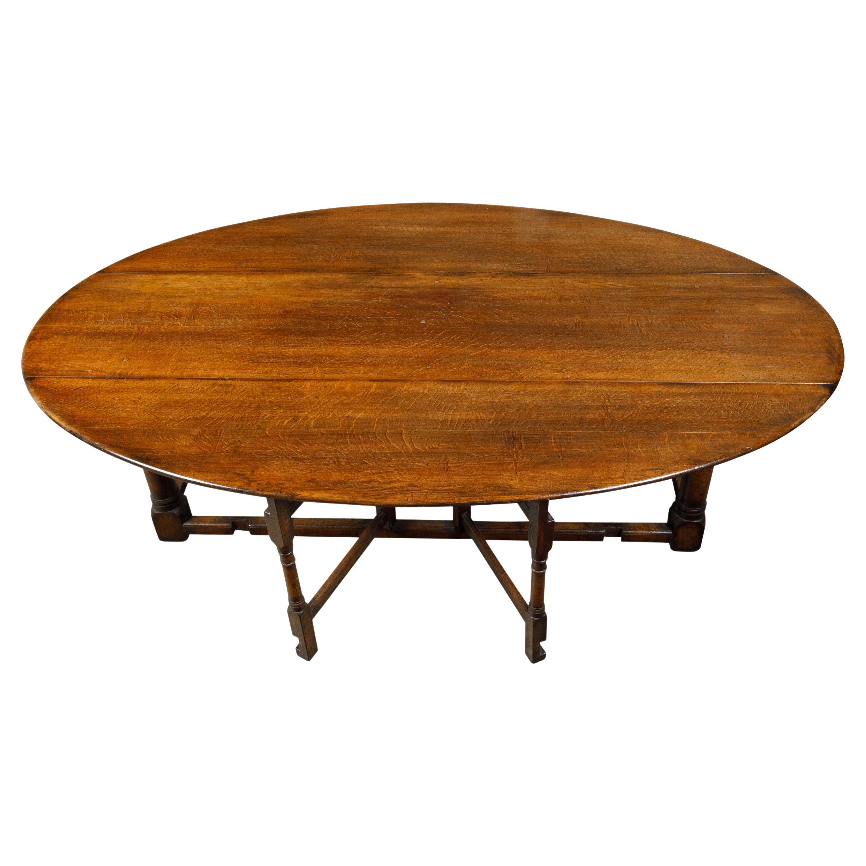 English 19th Century Oak Drop-Leaf Oval Top Table with Gateleg Base