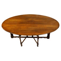 Antique English 19th Century Oak Drop-Leaf Oval Top Table with Gateleg Base