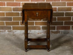 English 19th Century Oak Drop Leaf Table with Swivel Legs and Single Drawer