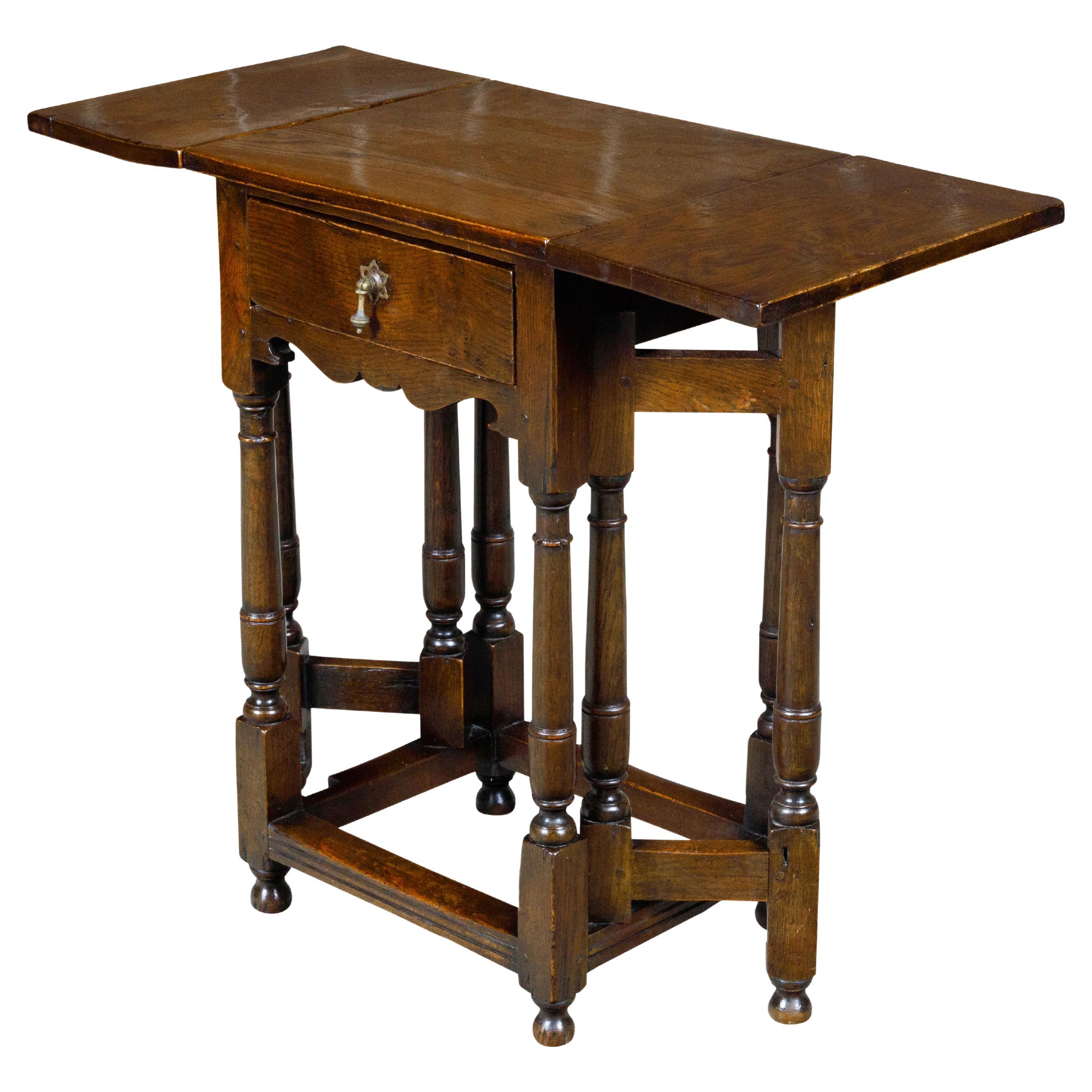 English 19th Century Oak Drop Leaf Table with Swivel Legs and Single Drawer For Sale