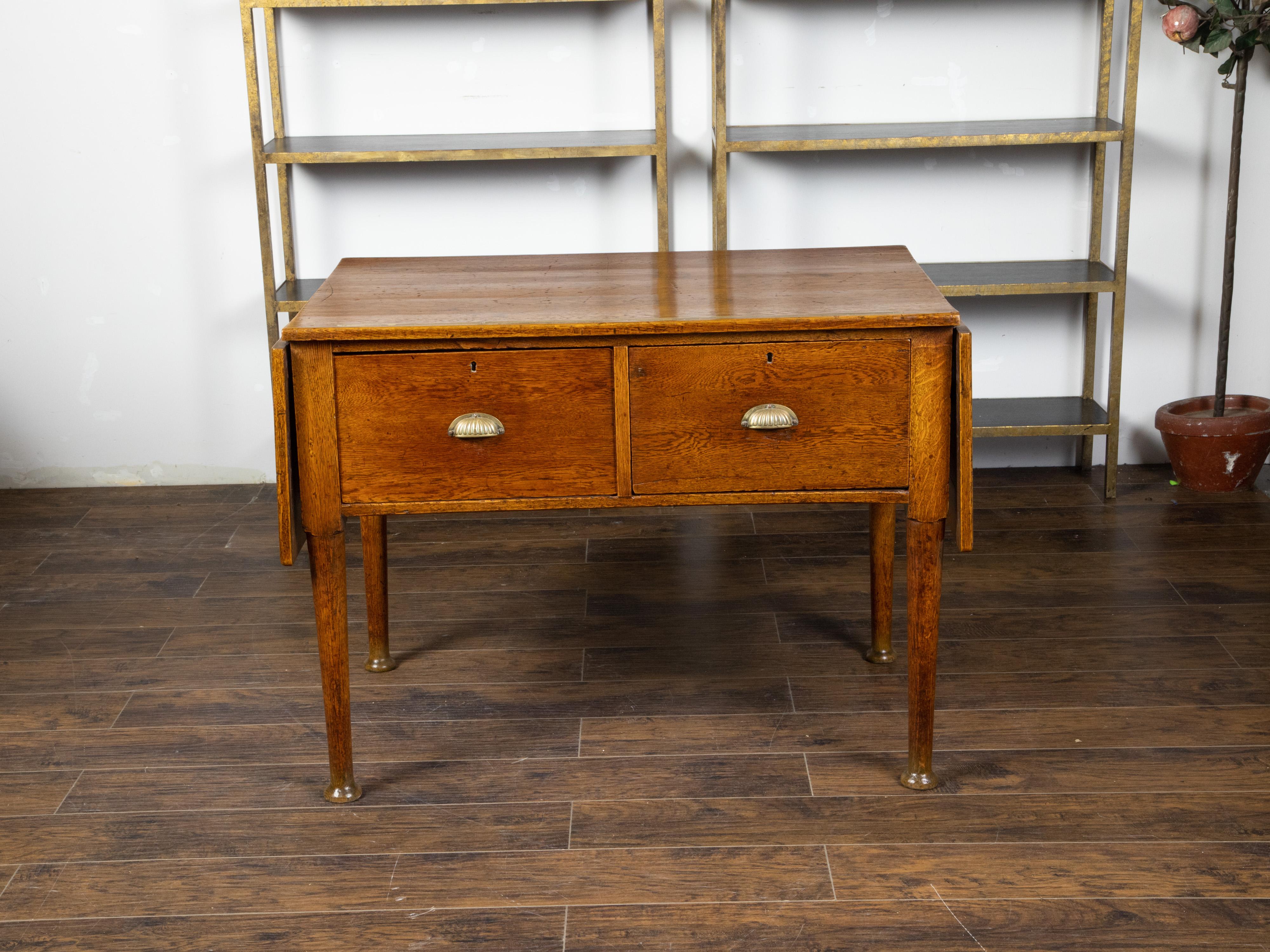 An English oak draper's table from the 19th century, with brass measuring tape and drop leaves. Created in England during the 19th century, this oak table features a rectangular top with inlaid brass measuring tape flanked with two drop leaves (the