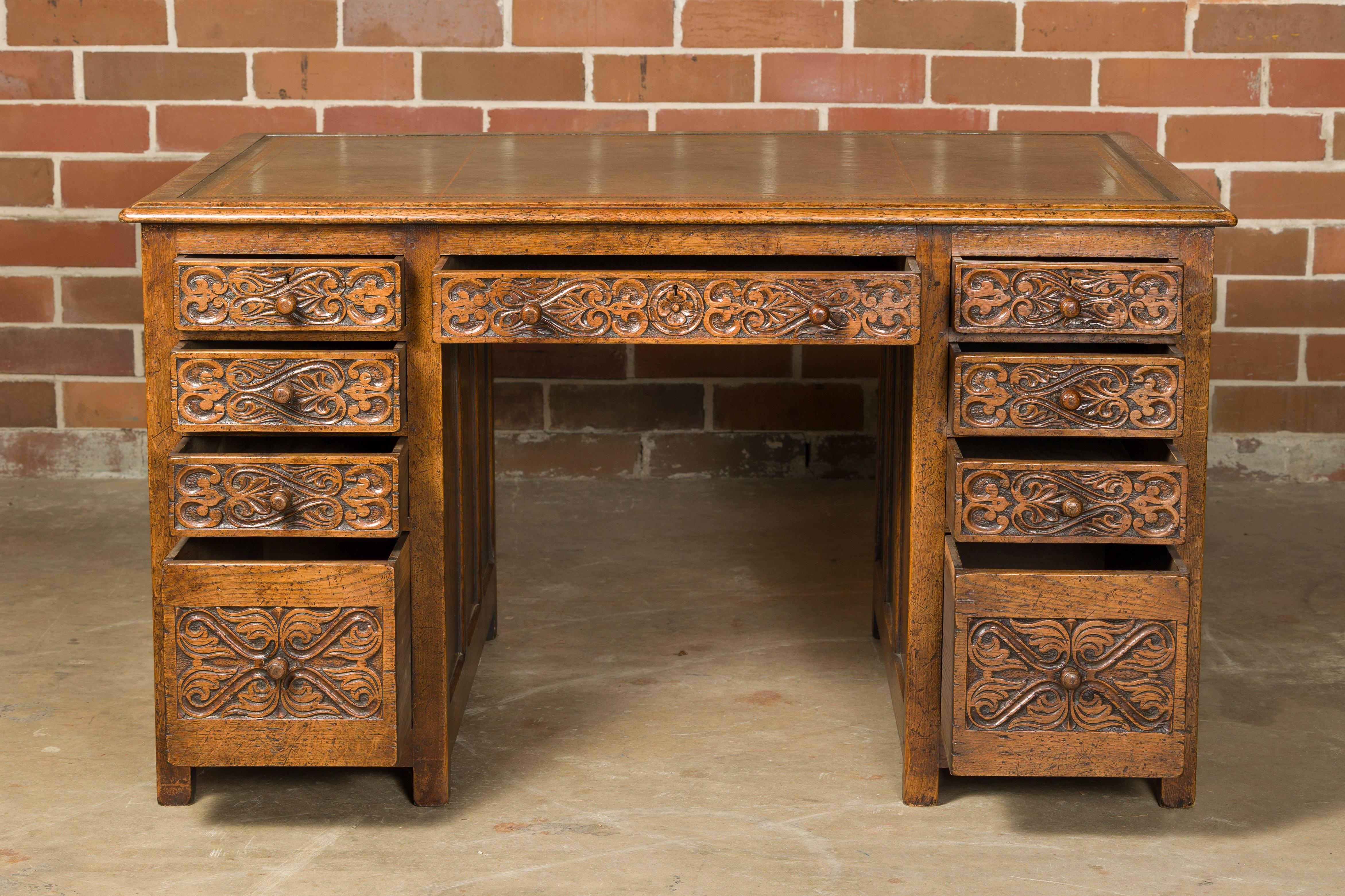 English 19th Century Oak Kneehole Desk with Nine Drawers and Carved Foliage In Good Condition For Sale In Atlanta, GA