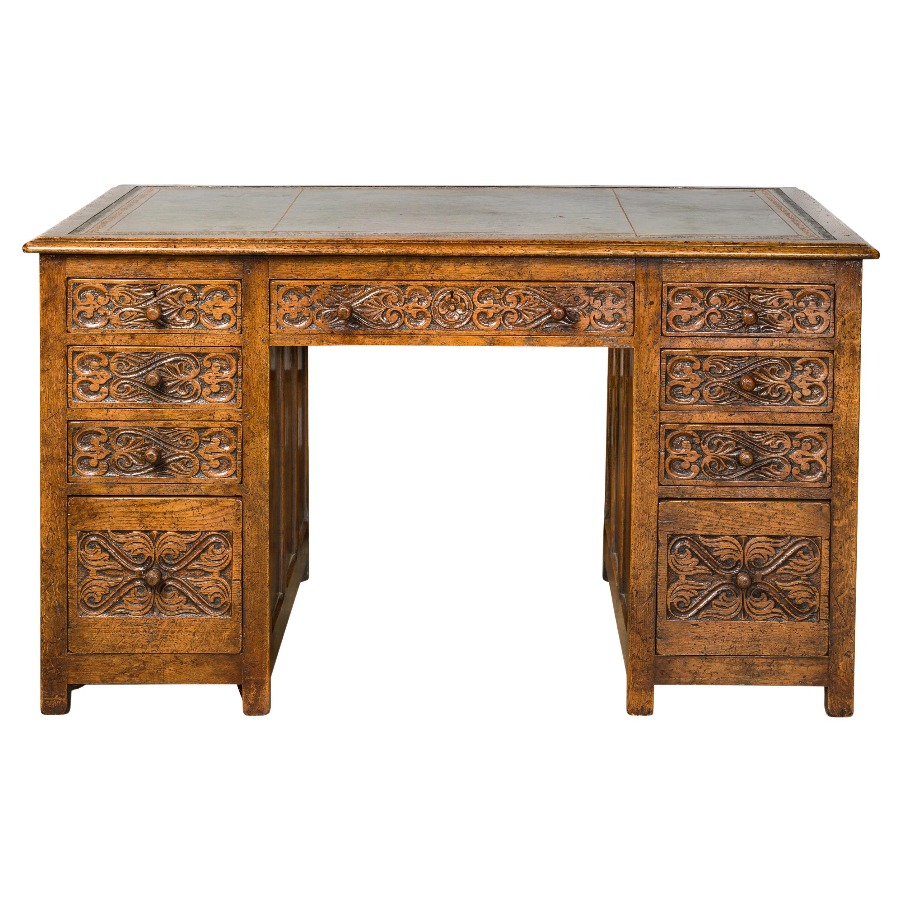English 19th Century Oak Kneehole Desk with Nine Drawers and Carved Foliage