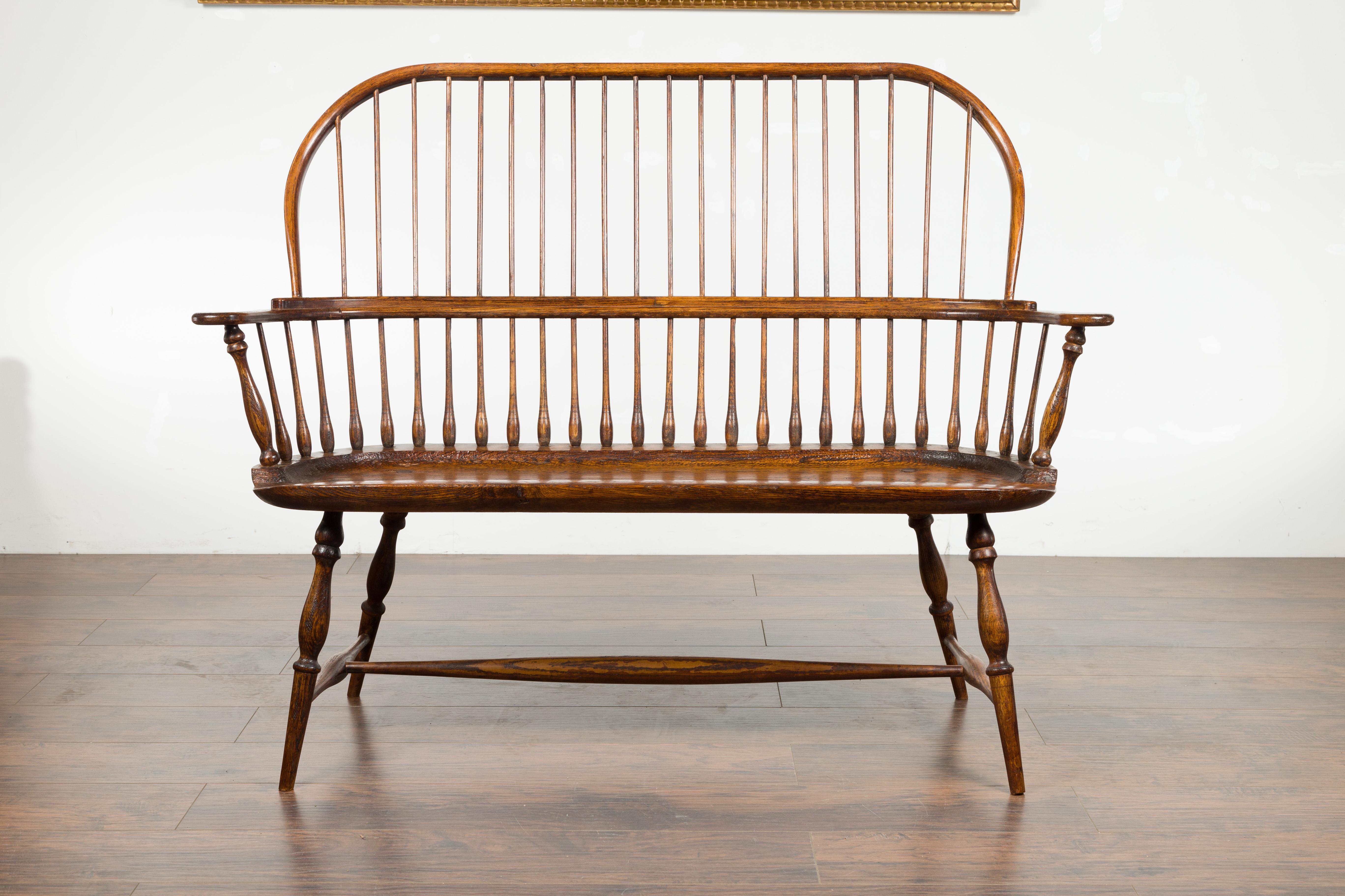 English 19th Century Oak Windsor Bench with Spindle Accents and Cross Stretcher 1