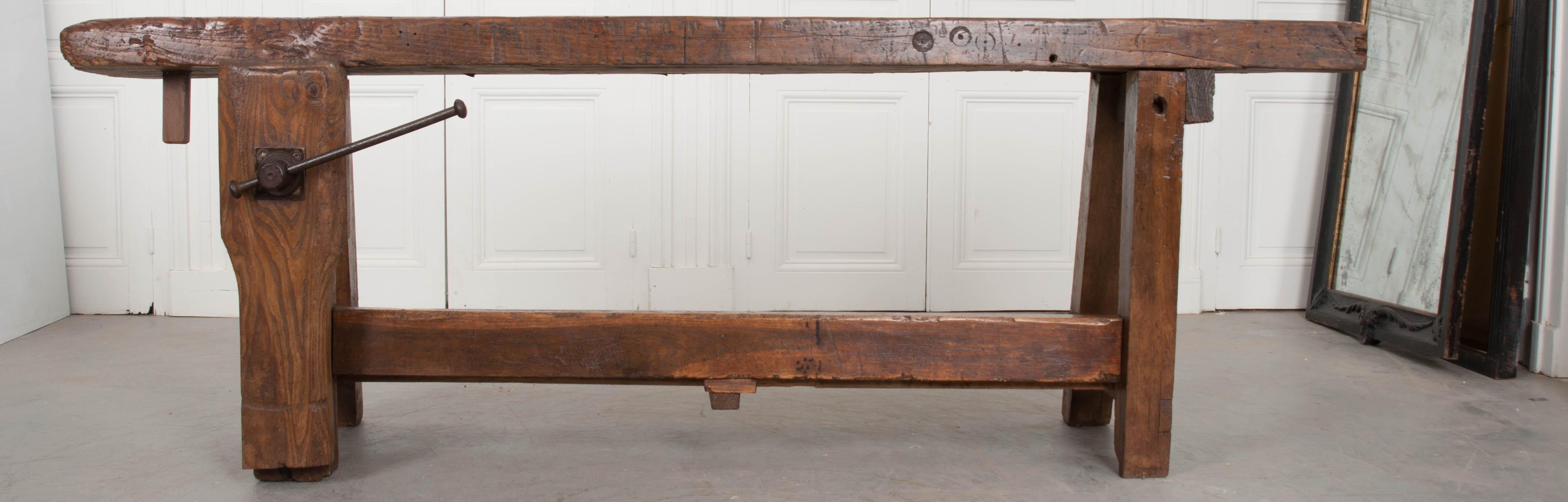 Antique workbenches have a way of telling their story more than most other antiques. They are raw and honest, with scars worn proudly from projects past. Saw marks, dings and dents only improve their charismatic appeal. This bench was made of solid