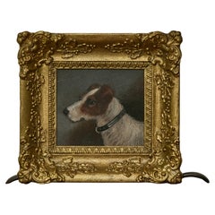 Dipinto inglese del XIX secolo a olio su tavola raffigurante un cane terrier in una cornice dorata intagliata