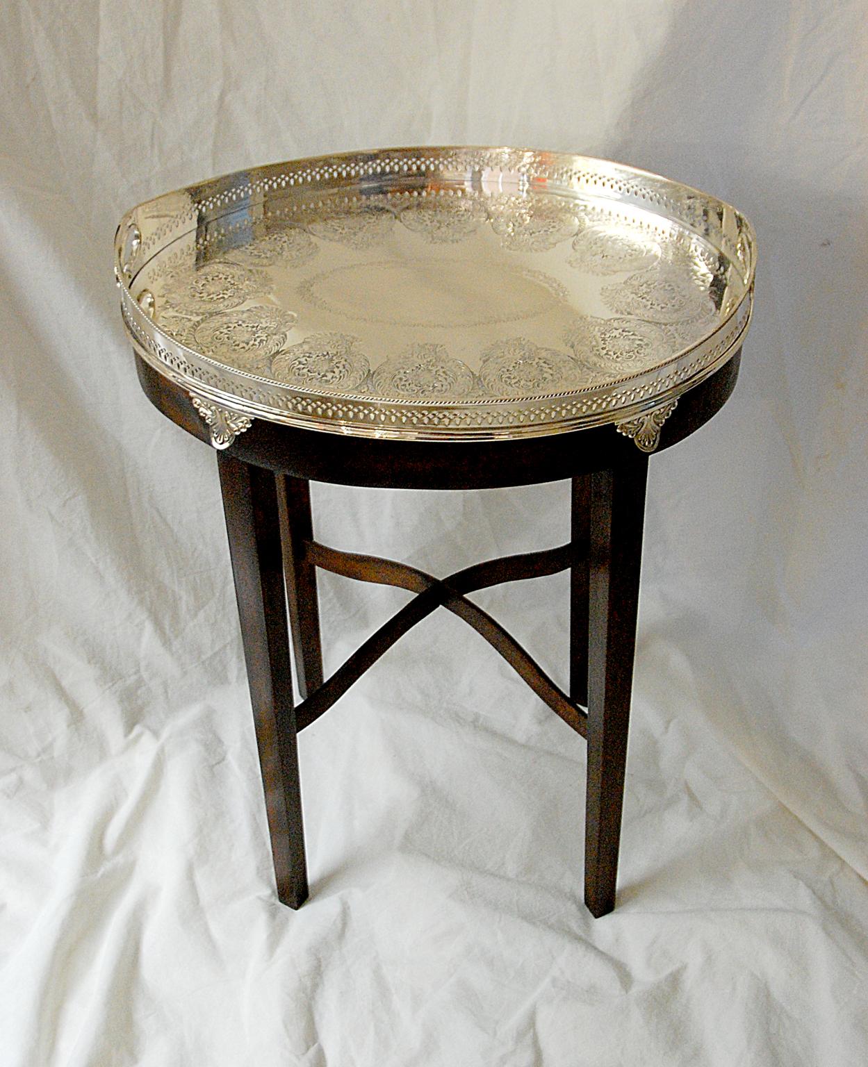 English 19th century silver plate galleried, footed tray by A. Beardshaw & Co.. This deeply hand engraved, oval galleried tray with integral handles has fine cast feet which are highlighted by the dark mahogany custom made stand. This heavy weight