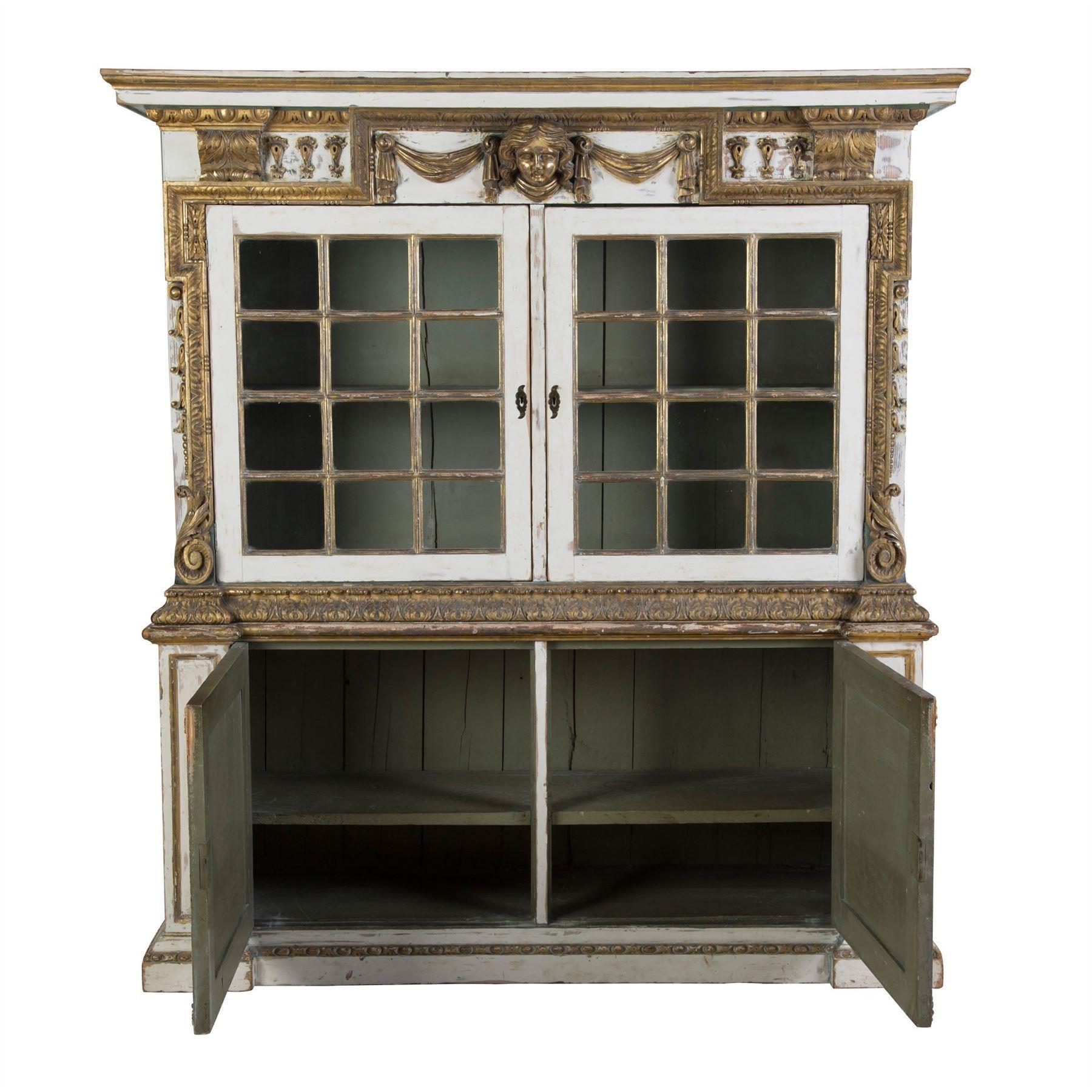 English 19th century Kentian style cupboard with gilded, carved wood details.