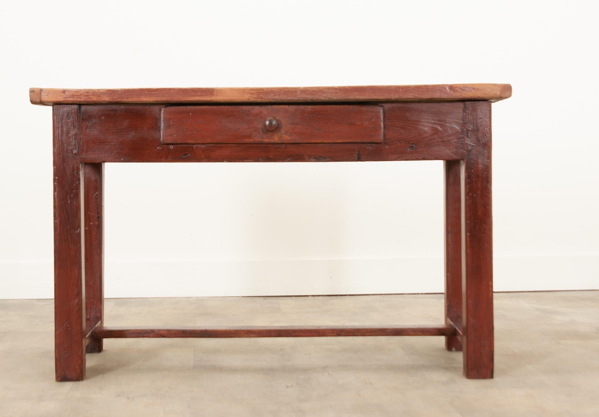 This simple console was hand-crafted of solid pine in 19th century England. The rusticated pine top has incredible texture, a rich patina, and is a beautiful natural color. The apron houses a single wide drawer that opens easily with a simply turned