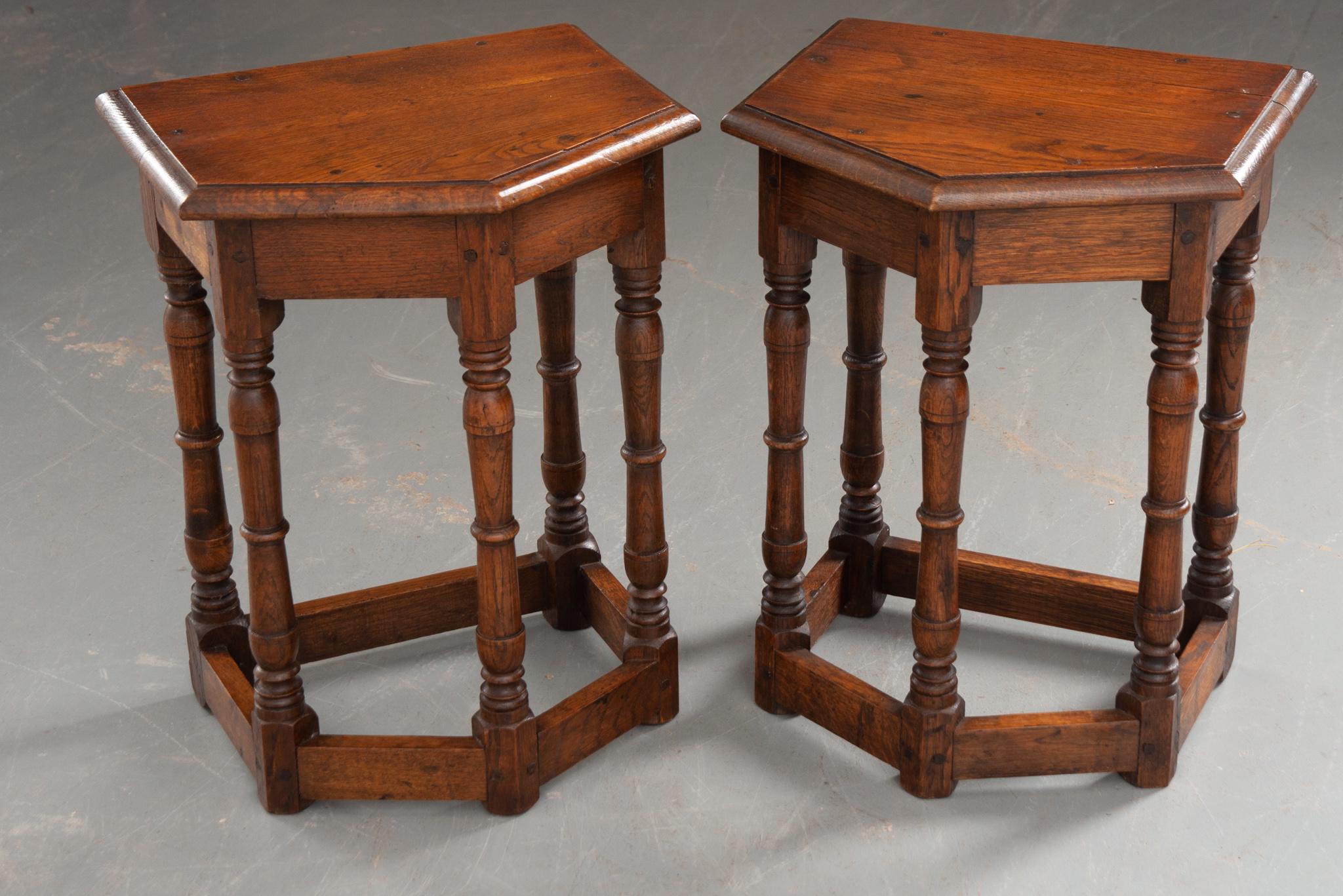 A pair of remarkable oak stools from England circa 1870. The irregular shaped pentagon top sits upon a plain apron and five symmetrical tuned legs, secured at the bottom by a stretcher that matches the unconventional top. These are beautifully hand