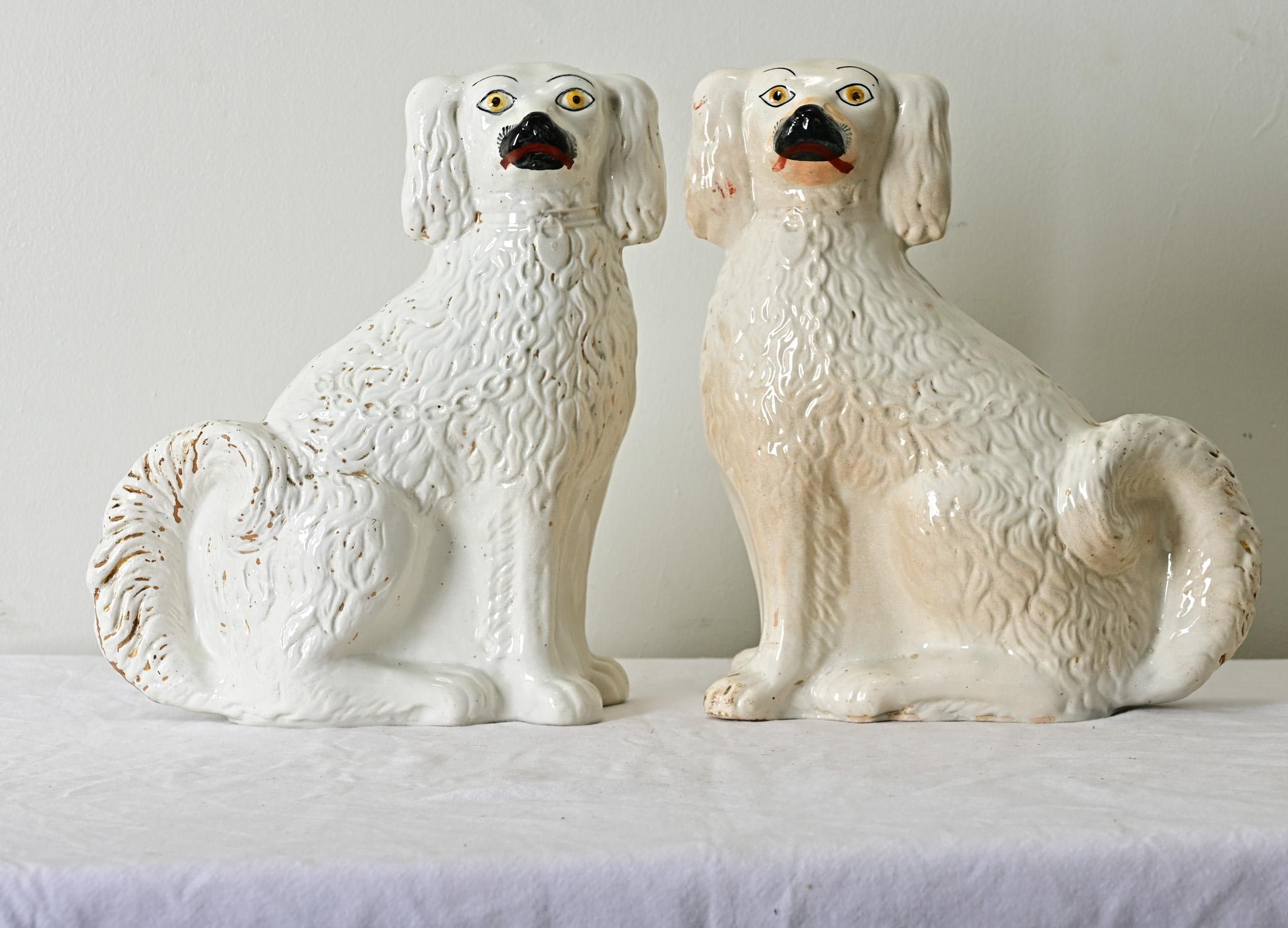 A darling couple of white Staffordshire spaniels from England, circa 1880. Patinated gold gilt accents within their fur and collar are a wonderful contrast to their glazed & textured white bodies. Make sure to view the detailed images to get a