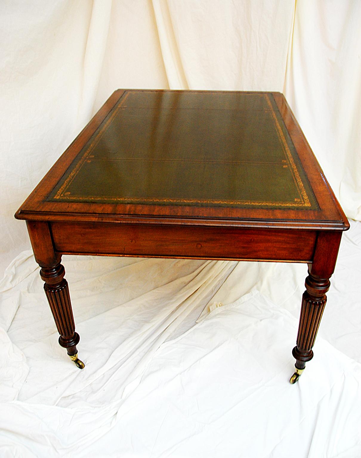 English 19th century partners writing table in mahogany with six drawers. This five foot by forty inch writing table is impressive in size and quality. The beautiful turned, tapered and reeded legs are in perfect proportions for a desk this size.