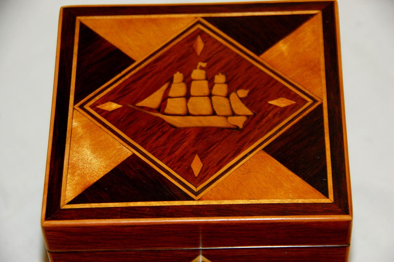 English Early 19th century partridgewood single tea caddy with three masted, square rigged ship inlaid to the lid. The ship is inlaid in shaded boxwood within a partridgewood diamond cartouche with satinwood diamonds in each corner and geometric