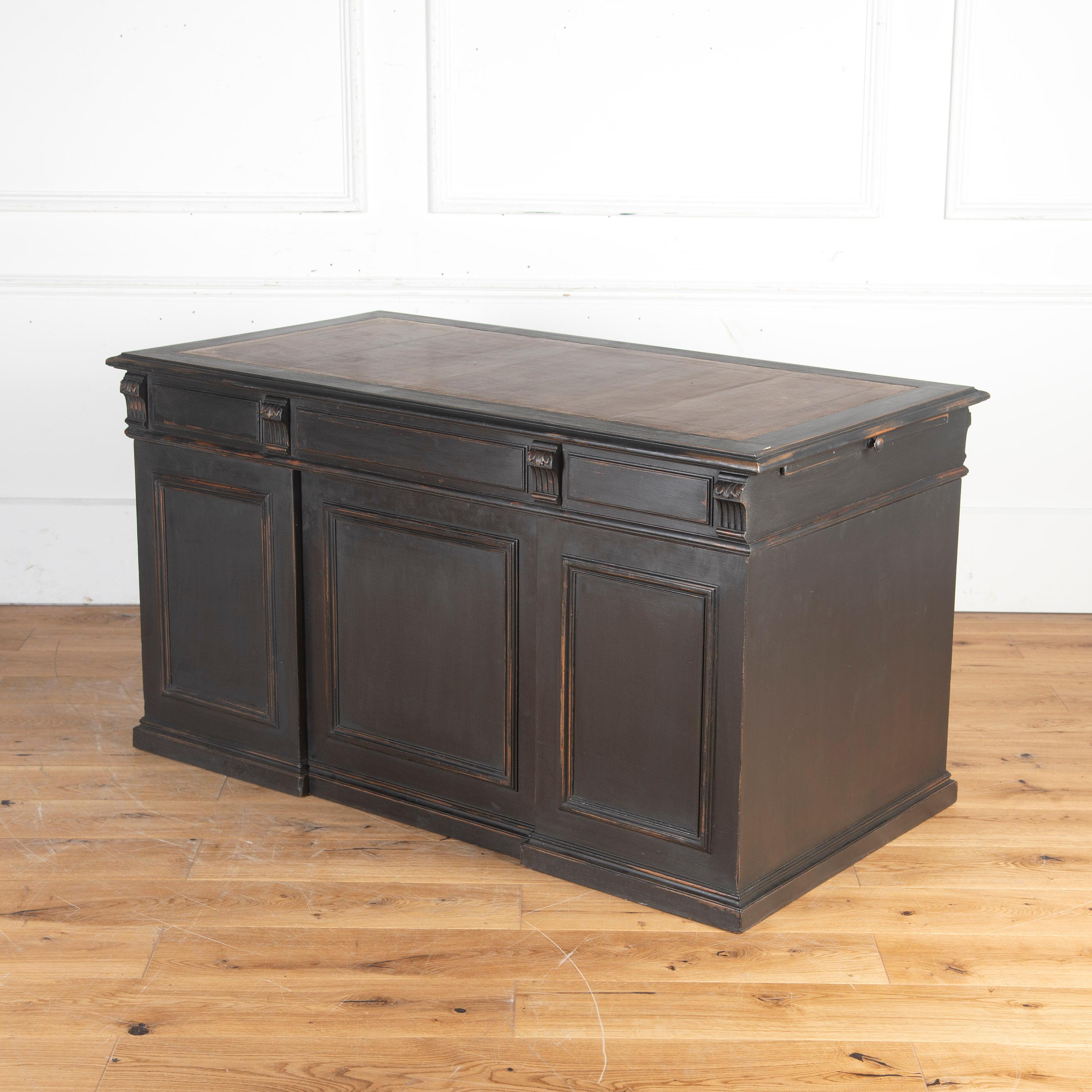 English 19th Century pedestal desk. 

This classic black-painted desk retains its original aged leather brown inset top. 

To one side are drawers and the other panels, so this piece can happily free-stand in a room.

The side with drawers